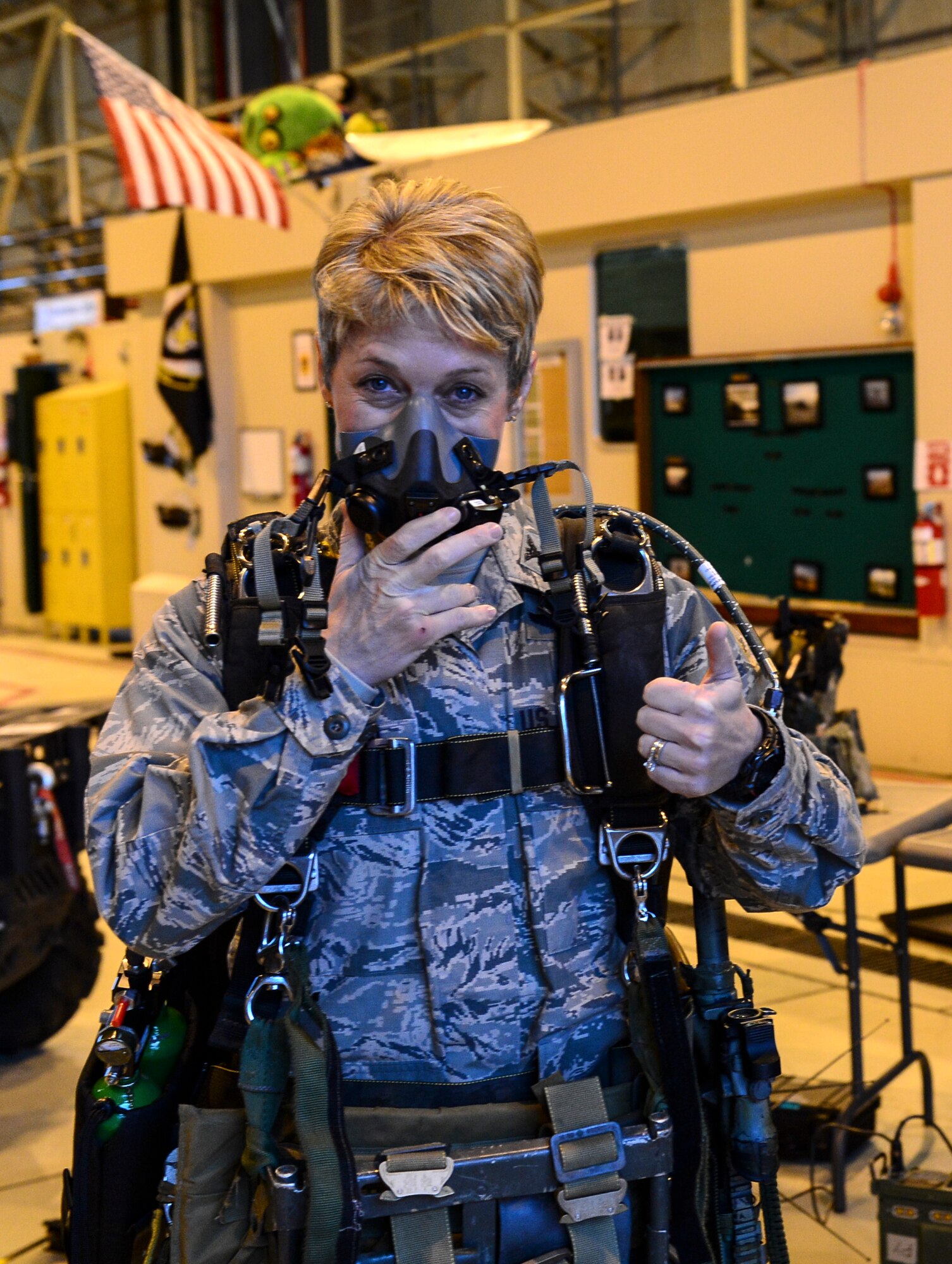 Col. Kristin Goodwin, 2nd Bomb Wing commander, gives a thumbs up after putting on all the gear needed for a military free-fall operation during an Installation Excellence Selection Board visit on Royal Air Force Lakenheath, England, Jan. 15, 2015. The 56th RQS is the only personnel recovery asset in U.S. Air Forces in Europe. (U.S. Air Force photo by Airman 1st Class Erin R. Babis/Released)