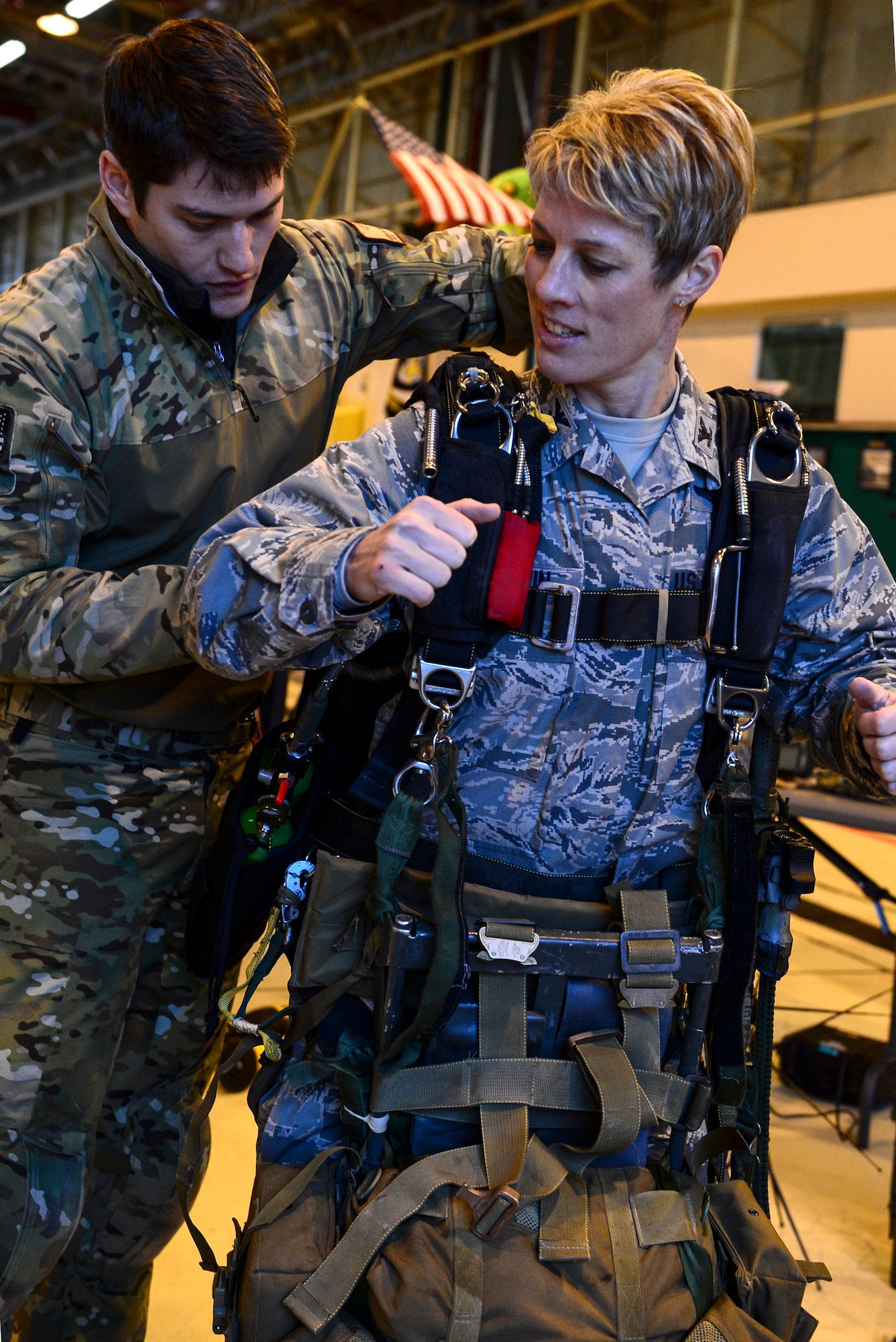 Staff Sgt. Andrew Williamson, left, 56th Rescue Squadron pararescueman, helps Col. Kristin Goodwin, 2nd Bomb Wing commander, put on jumpers oxygen and combat equipment for a military free fall operation during an Installation Excellence Selection Board visit on Royal Air Force Lakenheath, England, Jan. 15, 2015. The 56th RQS is the only personnel recovery asset in U.S. Air Forces in Europe. (U.S. Air Force photo by Airman 1st Class Erin R. Babis/Released)
