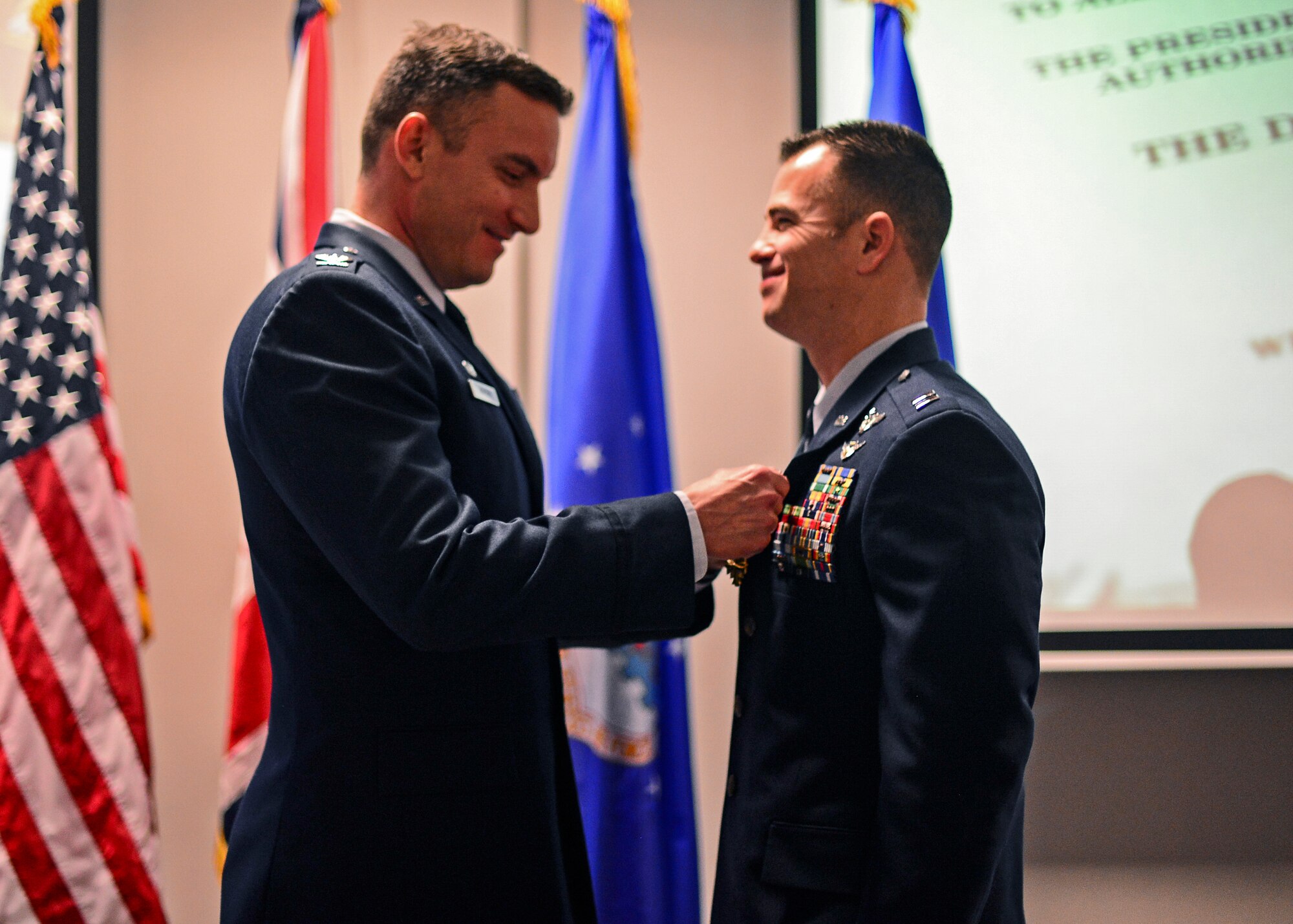 Col. Robert Novotny, 48th Fighter Wing commander, presents Capt. Michael Benitez, 492nd Fighter Squadron pilot, the Distinguished Flying Cross at the Strike Eagle Complex during an Installation Excellence Selection Board visit on Royal Air Force Lakenheath, England, Jan. 15, 2015. Benitez led two F-15Es responding to troops in a contact situation in support of Operation ENDURING FREEDOM in Afghanistan, May 21, 2014. (U.S. Air Force photo by Airman 1st Class Erin R. Babis/Released)