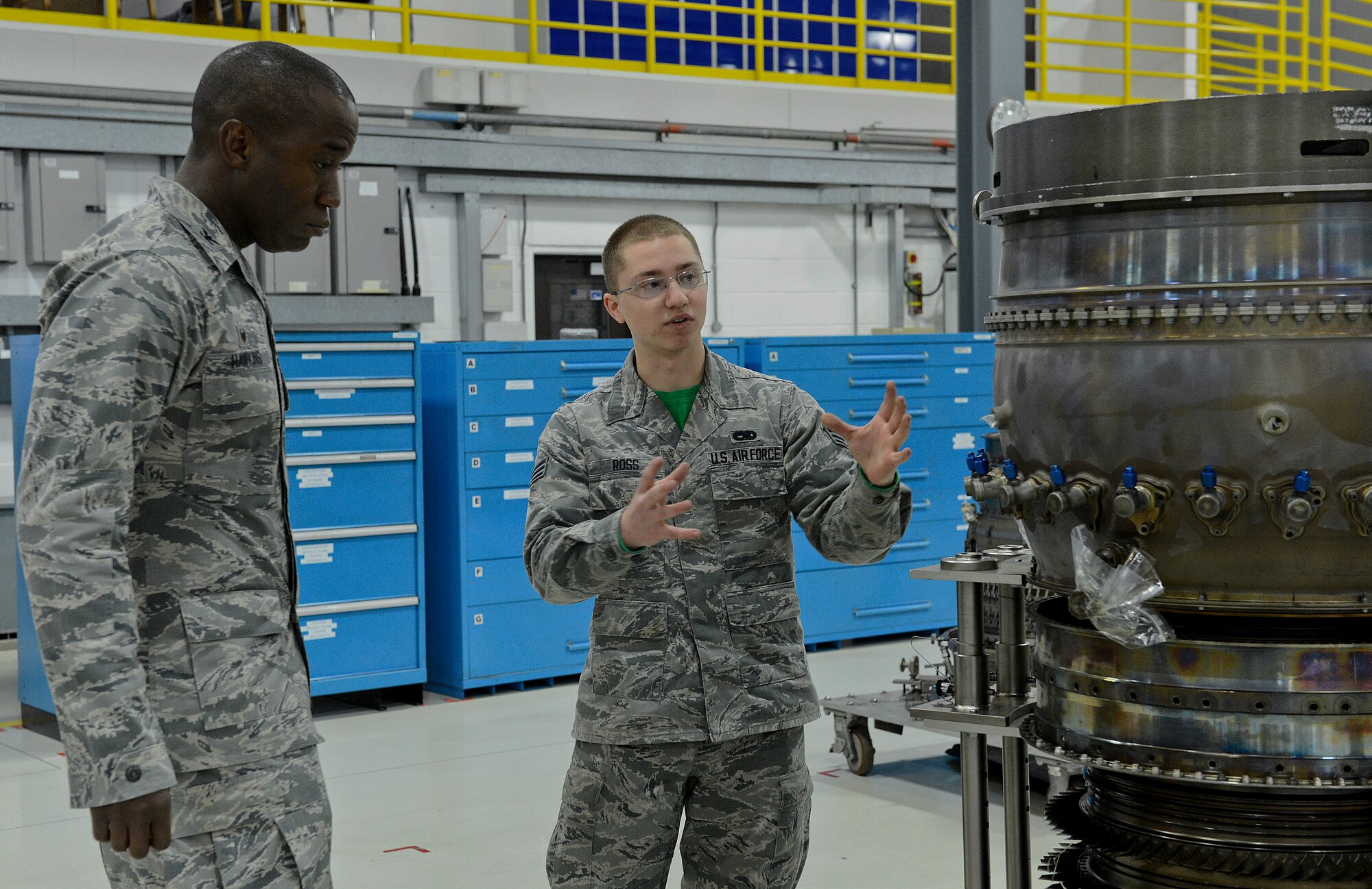 Senior Airman Colton Ross, 48th Component Maintenance Squadron aerospace propulsion journeyman, explains his job to Col. Stacey Hawkins, 10th Air Base Wing commander, during an Installation Excellence Selection Board visit on Royal Air Force Feltwell, England, Jan. 15, 2015. The IESB visited the Liberty Wing to determine the winner of the Commander in Chief’s Annual Award for Installation Excellence. (U.S. Air Force Photo/Airman 1st Class Trevor T. McBride/Released)