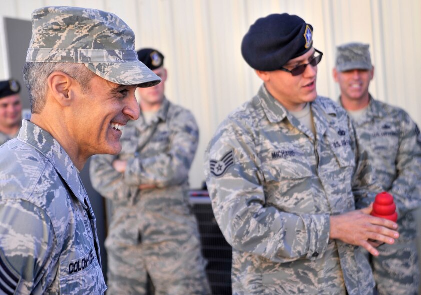 Staff Sgt. Christopher Michaud, 799th Security Forces Military Working Dog kennelmaster, right, briefs Chief Master Sgt. Ramon Colon-Lopez, U.S. Air Forces Central Command command chief about the duties of the MWD program during a visit Jan. 15, 2015, to Creech Air Force Base, Nevada. After the briefing, the kennelmaster and MWD handlers provided a demonstration of how they operate in certain real-world situations. (U.S. Air Force photo by Airman 1st Class Christian Clausen/Released)
