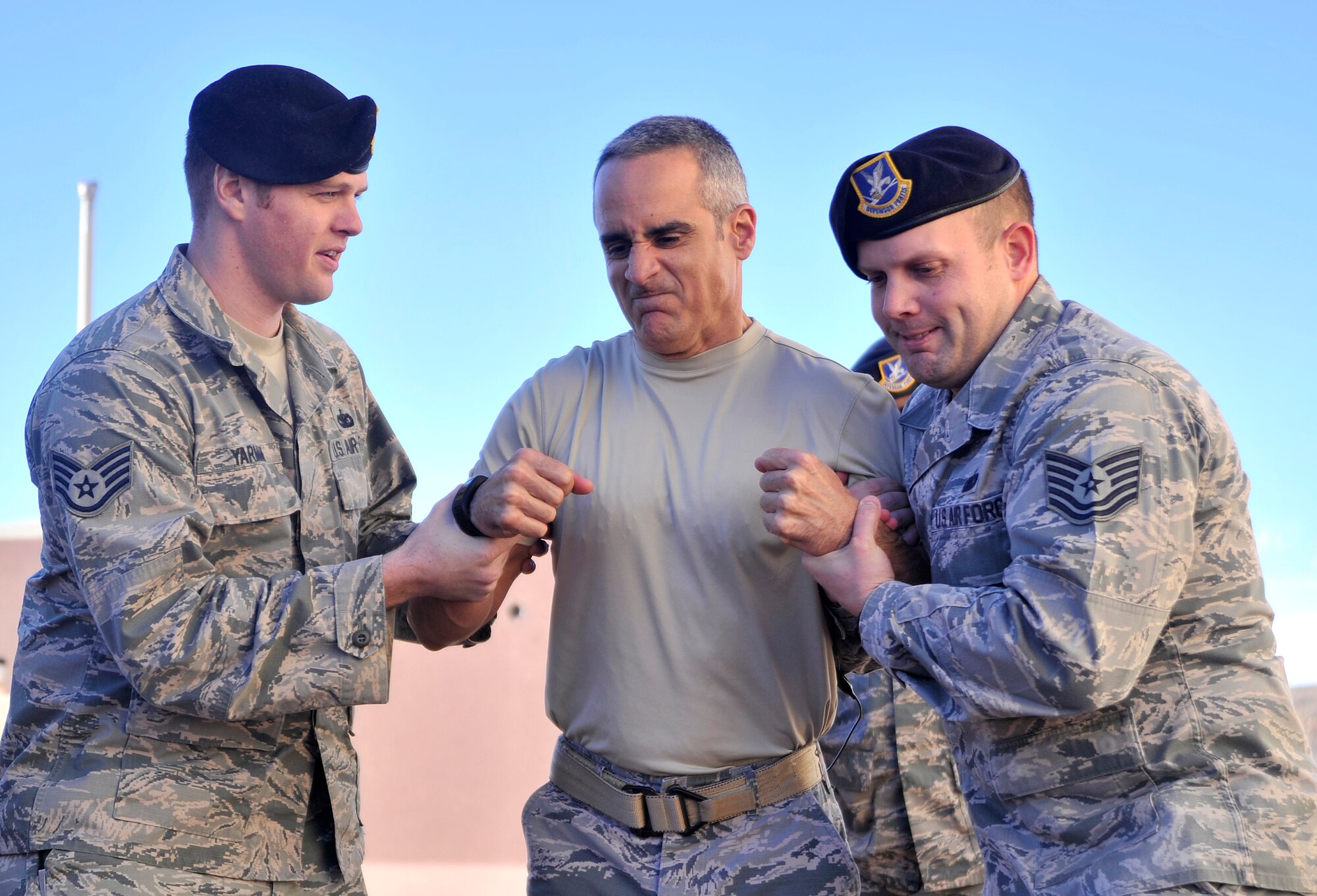 Chief Master Sgt. Ramon Colon-Lopez, U.S. Air Forces Central Command command chief gets tasered while 799th Security Forces Airmen hold him up Jan. 15, 2015, during a visit to Creech Air Force Base, Nevada. The 799th SFS Airmen briefed the chief about the uses of a taser, provided a demonstration, and provided an opportunity for the chief to be tasered. (U.S. Air Force photo by Airman 1st Class Christian Clausen/Released)