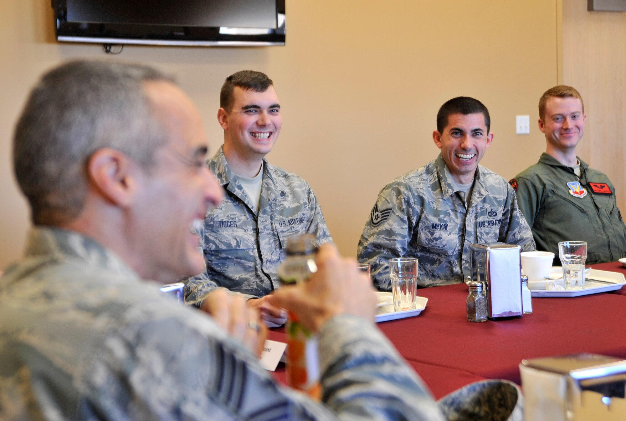 Chief Master Sgt. Ramon Colon-Lopez, U.S. Air Forces Central Command command chief, left, laughs with Airmen during a luncheon as part of his visit Jan. 15, 2015, to Creech Air Force Base, Nevada. During the luncheon, Airmen addressed concerns about quality of life, situational circumstances, and changes in the Air Force. (U.S. Air Force photo by Airman 1st Class Christian Clausen/Released)