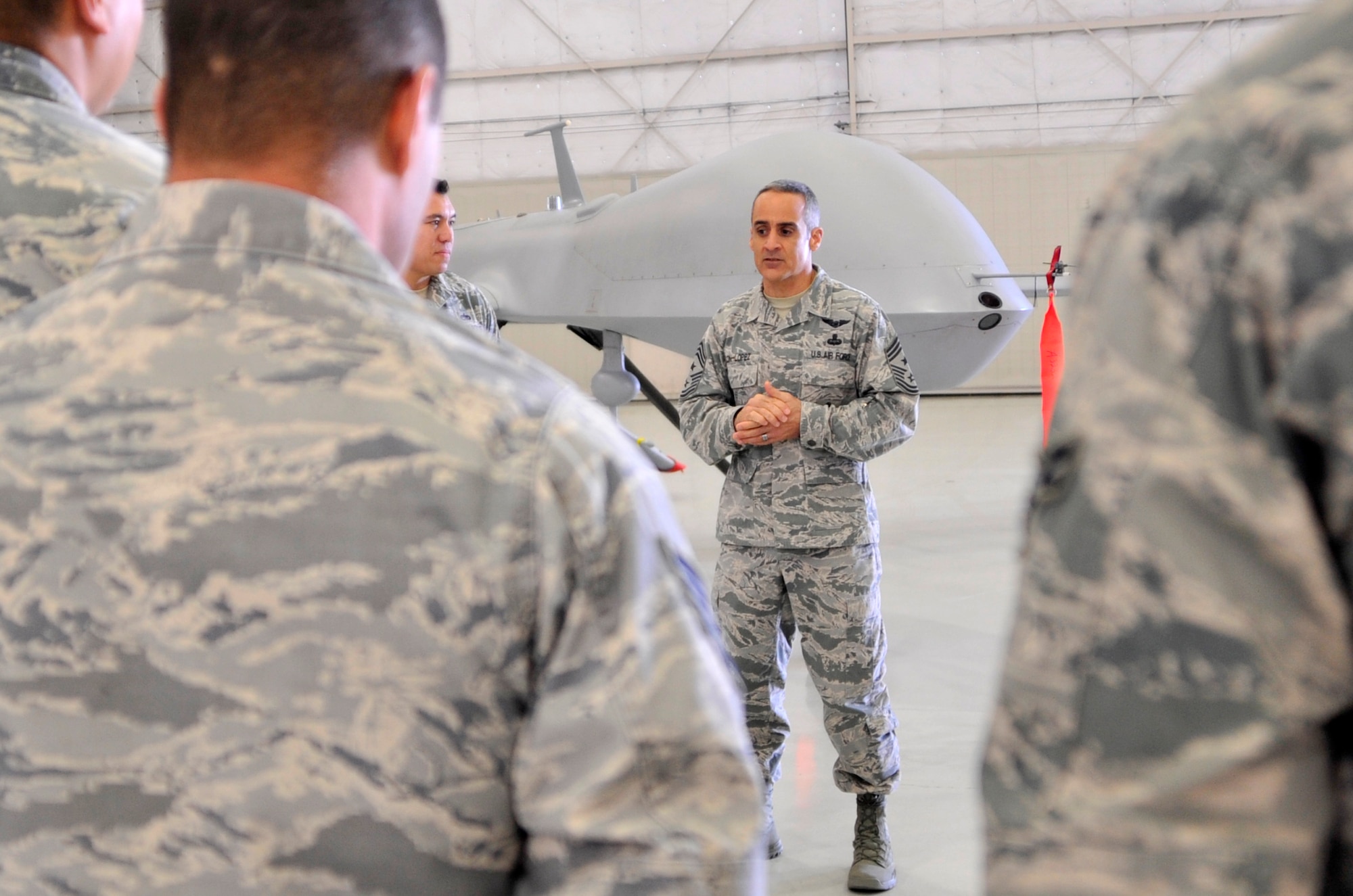 Chief Master Sgt. Ramon Colon-Lopez, U.S. Air Forces Central Command command chief, shares stories with Airmen assigned to the 432nd Maintenance Group during his visit Jan. 15, 2015, to Creech Air Force Base, Nevada. The chief visited squadrons around the base to spend time with Airmen, answer their questions and receive feedback. (U.S. Air Force photo by Airman 1st Class Christian Clausen/Released)