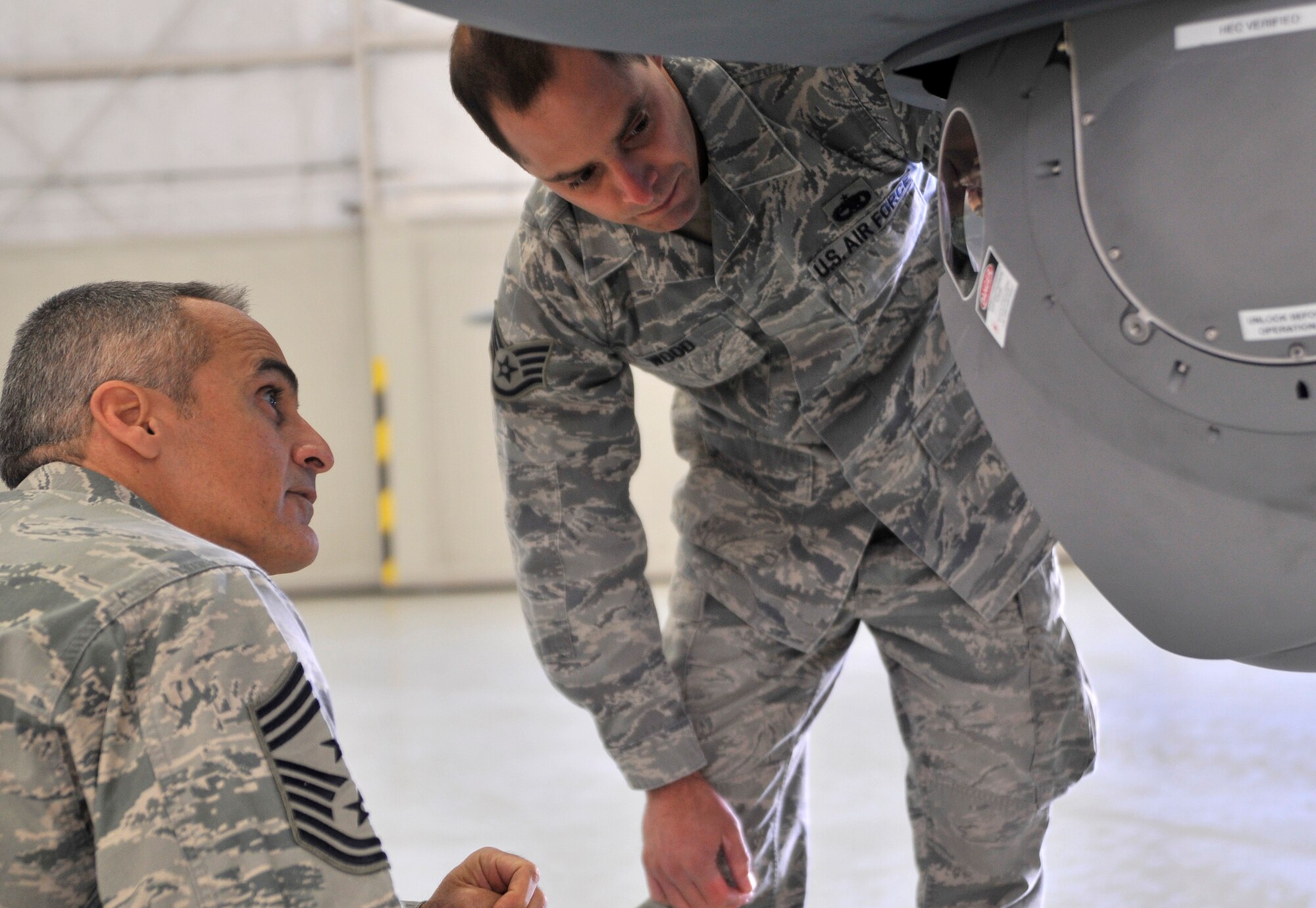 Staff Sgt. Nathan Wood, 432nd Aircraft Maintenance Squadron Avionics supervisor, right, briefs Chief Master Sgt. Ramon Colon-Lopez, U.S. Air Forces Central Command command chief about the multi-targeting spectral ball on an MQ-9 Reaper remotely piloted aircraft during his visit Jan. 15, 2015, to Creech Air Force Base, Nevada. During his visit the chief stressed to Airmen that no matter what they do or how far the area of responsibility is, they’re making a difference 24/7, 365. (U.S. Air Force photo by Airman 1st Class Christian Clausen/Released)