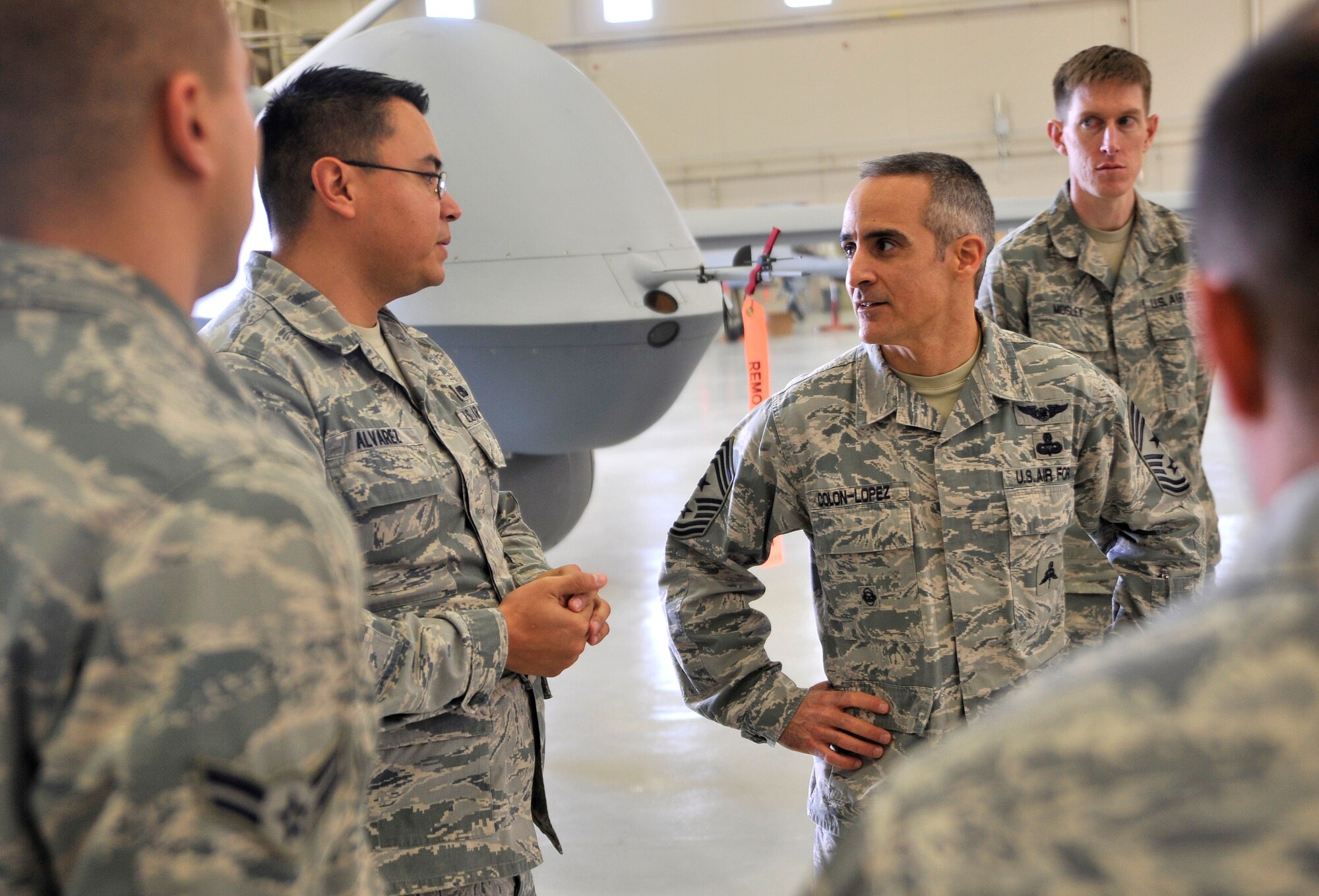 Airmen from the 432nd Maintenance Group brief Chief Master Sgt. Ramon Colon-Lopez, U.S. Air Forces Central Command command chief, about MQ-1 Predator and MQ-9 Reaper remotely piloted aircraft during his visit Jan. 15, 2015, to Creech Air Force Base, Nevada. The chief visited squadrons around the base to spend time with Airmen, answer their questions, and receive feedback. (U.S. Air Force photo by Airman 1st Class Christian Clausen/Released)
