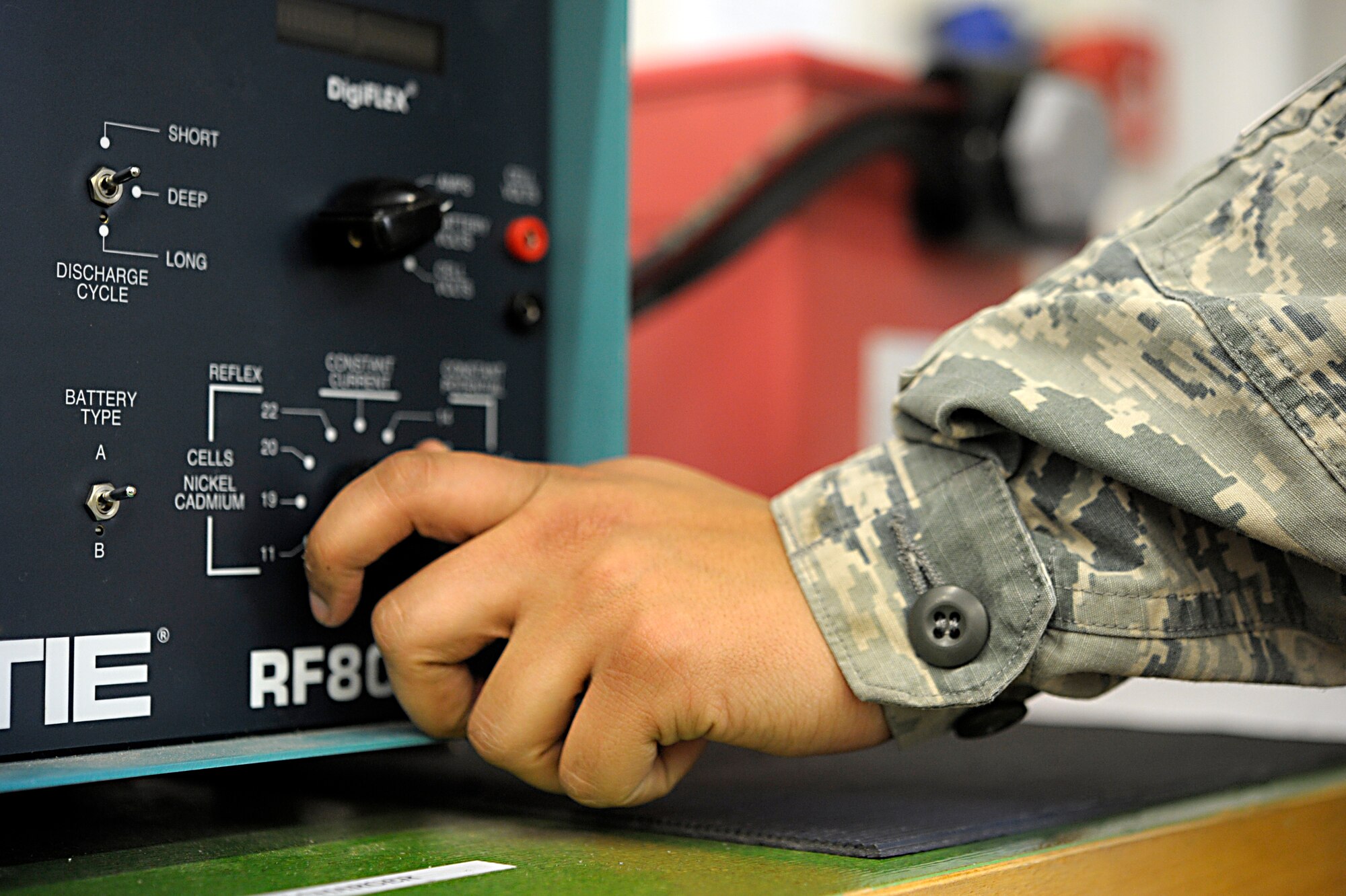 Senior Airman Gabriel Sundstrom, 86th Maintenance Squadron electrical and environmental specialist, adjusts a dial on a battery load tester at Ramstein Air Base, Germany, Jan. 15, 2015. By adjusting the tester to the setting specified in the technical order, electrical and environmental specialists check to make sure a battery is still serviceable. (Senior Airman Timothy Moore/Released)