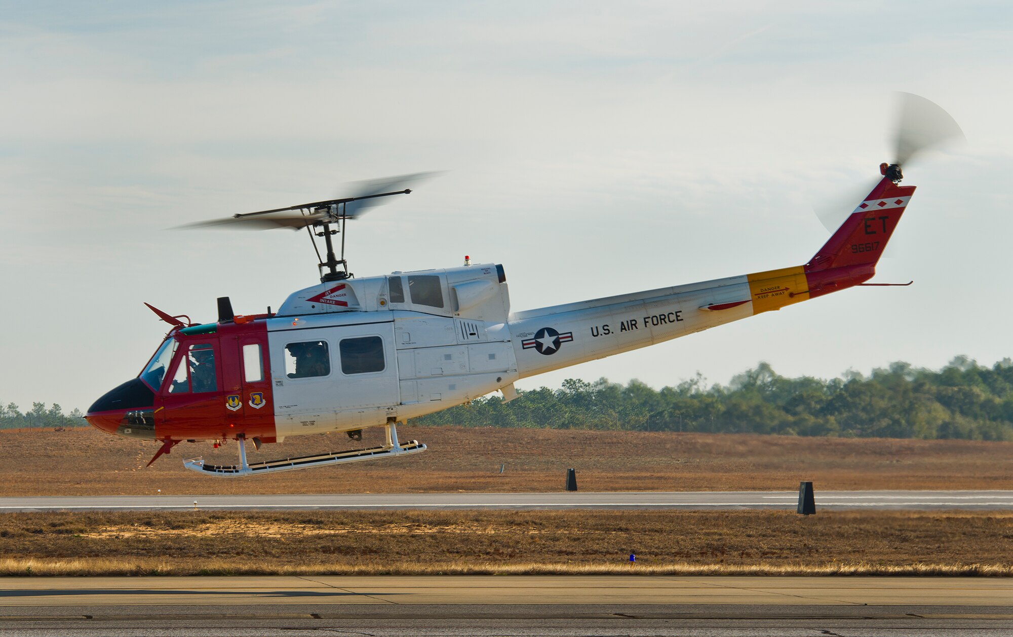 A 413th Flight Test Squadron UH-1 Huey lifts off from the flightline at Duke Field, Fla.  The 413th FLTS provides developmental testing to rotary wing aircraft such as the UH-1, CV-22 and the C-130.  (U.S. Air Force photo/Samuel King Jr.)