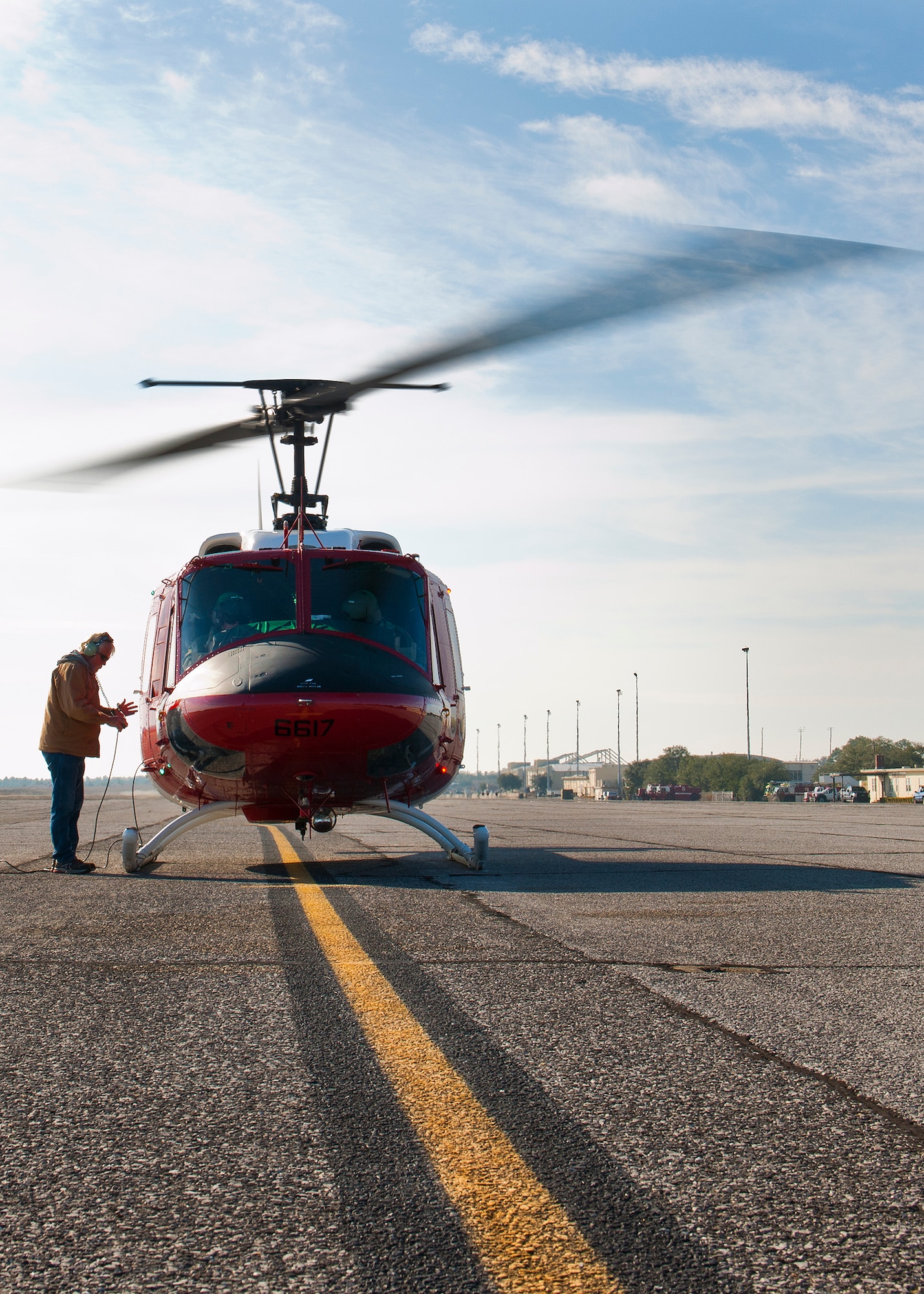 William Kelly, 96th Aircraft Maintenance Squadron, performs preflight checks on the 413th Flight Test Squadron’s UH-1 Huey at Duke Field, Fla.  Civilian employees provide maintenance for the 413th’s helo test missions.  (U.S. Air Force photo/Samuel King Jr.)