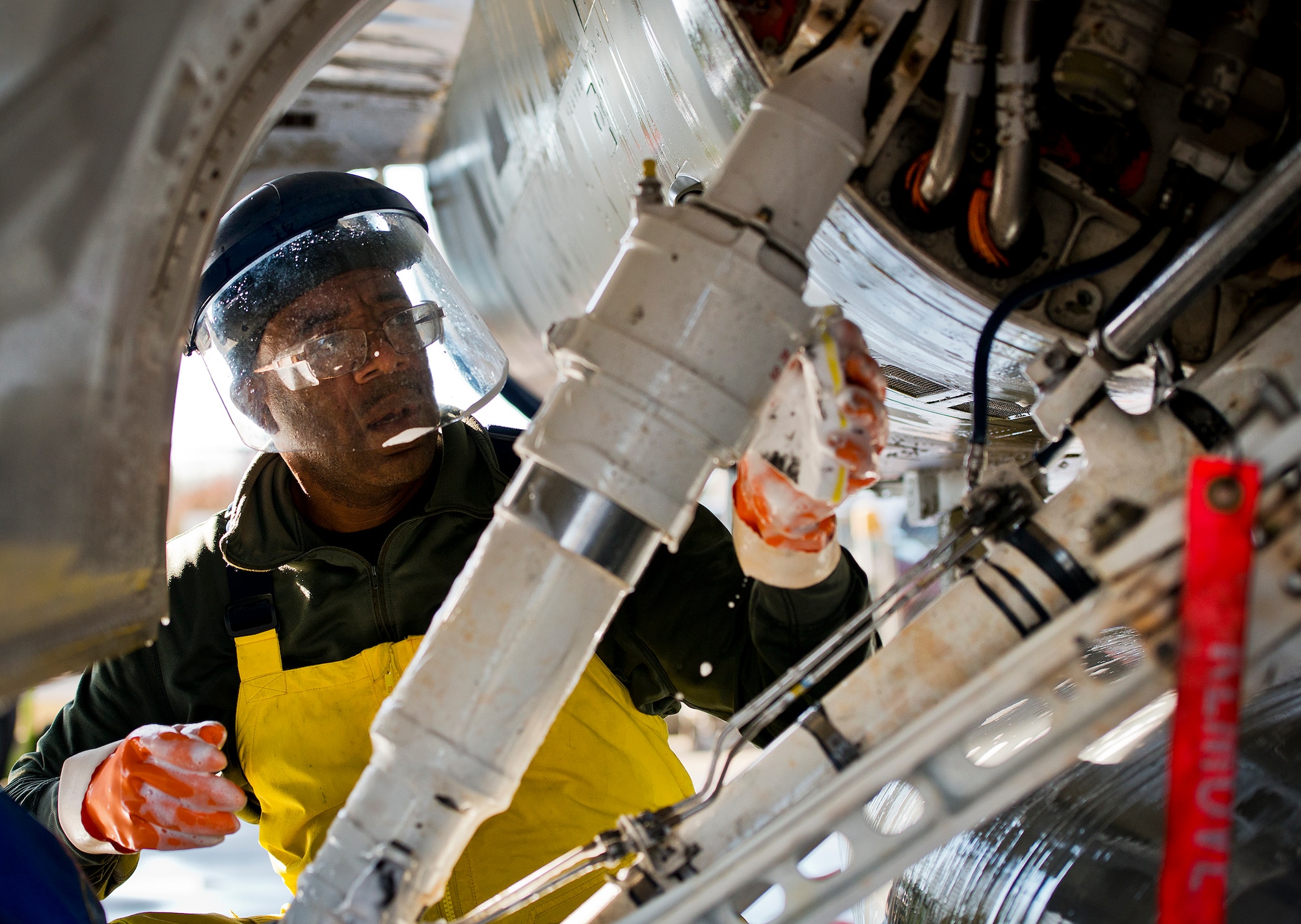 Mike Whyte, a contractor with PAE, scrubs down the side of an F-16 Fighting Falcon during a morning wash at Eglin Air Force Base, Fla.  PAE maintains the 96th Test Wing wash rack and also supports armament, engines, sheet metal, aero repair, metals tech, non-destructive inspection, aircraft phase dock and fuels repair shop. (U.S. Air Force photo/Samuel King Jr.)