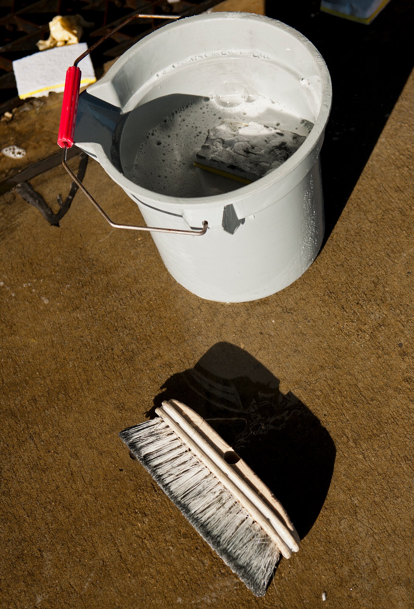 A soapy bucket and brush are just two of the tools used by the jet washers of PAE, the contracting company responsible for keeping Eglin Air Force Base’s aircraft clean.  PAE maintains the 96th Test Wing wash rack and also supports armament, engines, sheet metal, aero repair, metals tech, non-destructive inspection, aircraft phase dock and fuels repair shop. (U.S. Air Force photo/Samuel King Jr.)