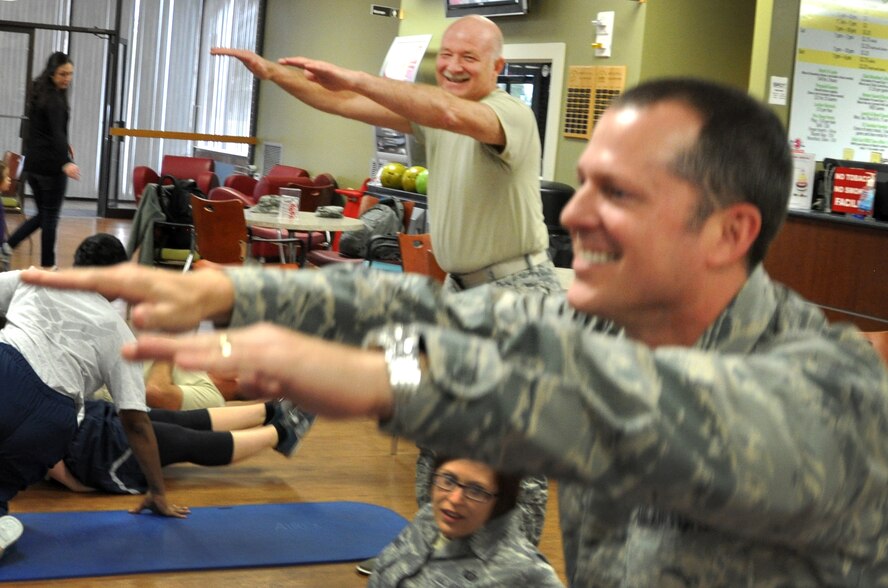Chief Master Sgt. Ken Koyles, superintendent of the 476th Fighter Group, laughs at Col. James Travis, commander of the 476th Fighter Group, as the two complete squats during a combat bowling teambuilding challenge January 11, at Moody Air Force Base, Georgia. Combat bowling penalizes opponents with activities such as pushups, setups or jumping jacks based on the bowling pins knocked down. Wright chose to take the detachment bowling during their Unit Training Assembly as an indoor inclimate weather activity. (Photo by Tech. Sgt. Emily F. Alley)