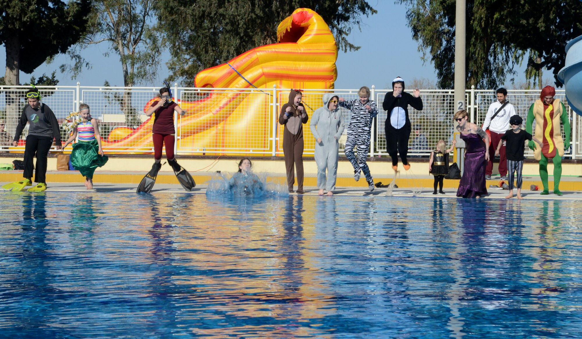 Members of Incirlik Air Base jump into the pool at the 2015 Polar Plunge Jan. 17, 2015, at Incirlik Air Base, Turkey. Many of the members quickly climbed out because of the freezing temperature, while a couple members continued to swim. (U.S. Air Force photo by Staff Sgt. Caleb Pierce/Released)