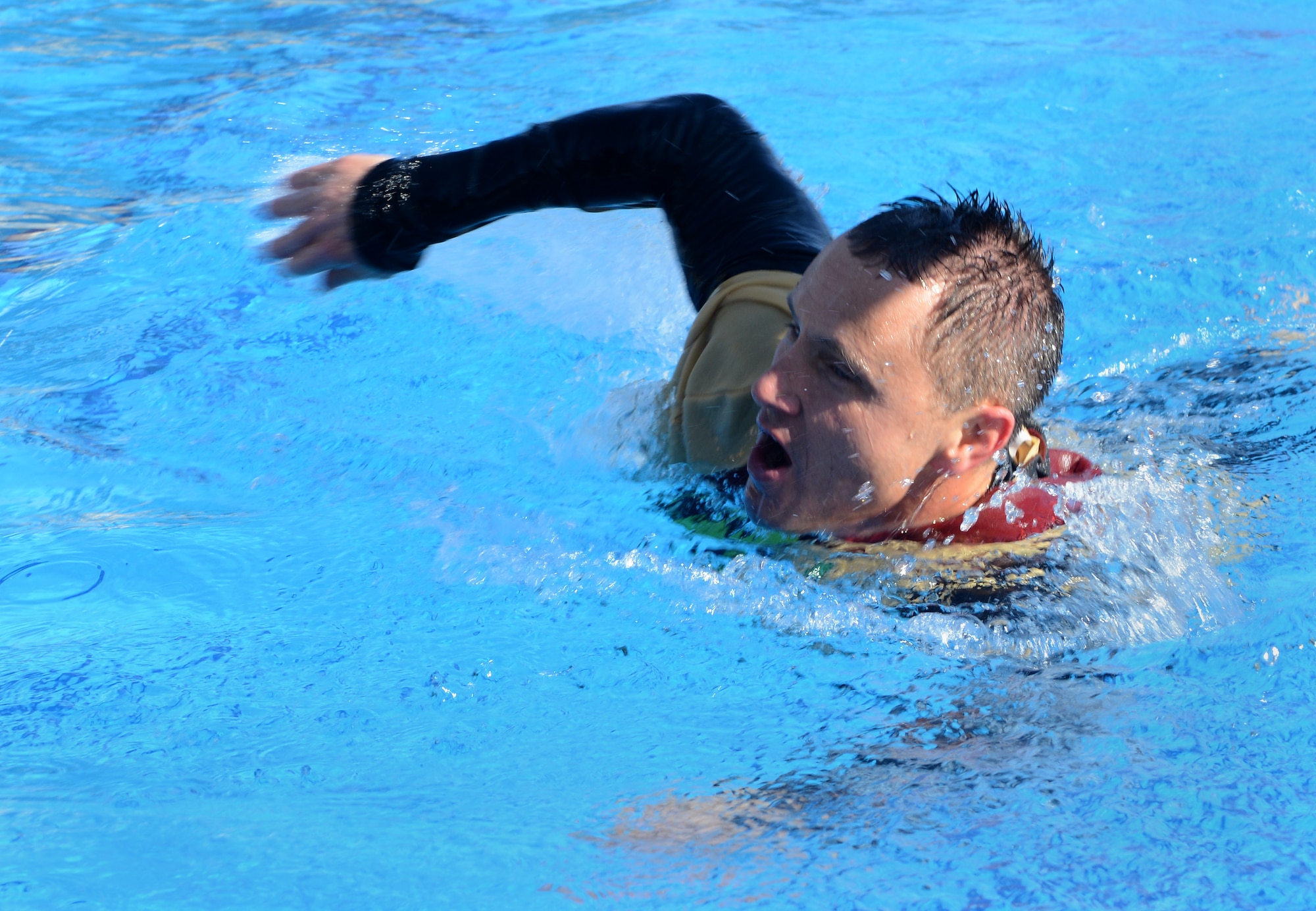 Maj. Hardy Giles, 39th Force Support Squadron commander, swims to the edge of the pool after jumping in during the 2015 Polar Plunge Jan. 17, 2015, at Incirlik Air Base, Turkey. The Polar Plunge is an annual event held at Incirlik, which gives members an opportunity to dress up in costumes and take a plunge into the frigid water of the base pool. (U.S. Air Force photo by Staff Sgt. Caleb Pierce/Released)
