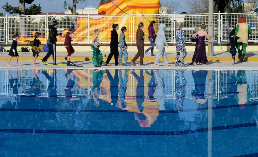 Members of Incirlik Air Base parade around the pool during the 2015 Polar Plunge Jan. 17, 2015, at Incirlik Air Base, Turkey. There were 15 jumpers who participated in the event, plunging into the base pool, which was recorded at 40 degrees Fahrenheit. (U.S. Air Force photo by Staff Sgt. Caleb Pierce/Released)