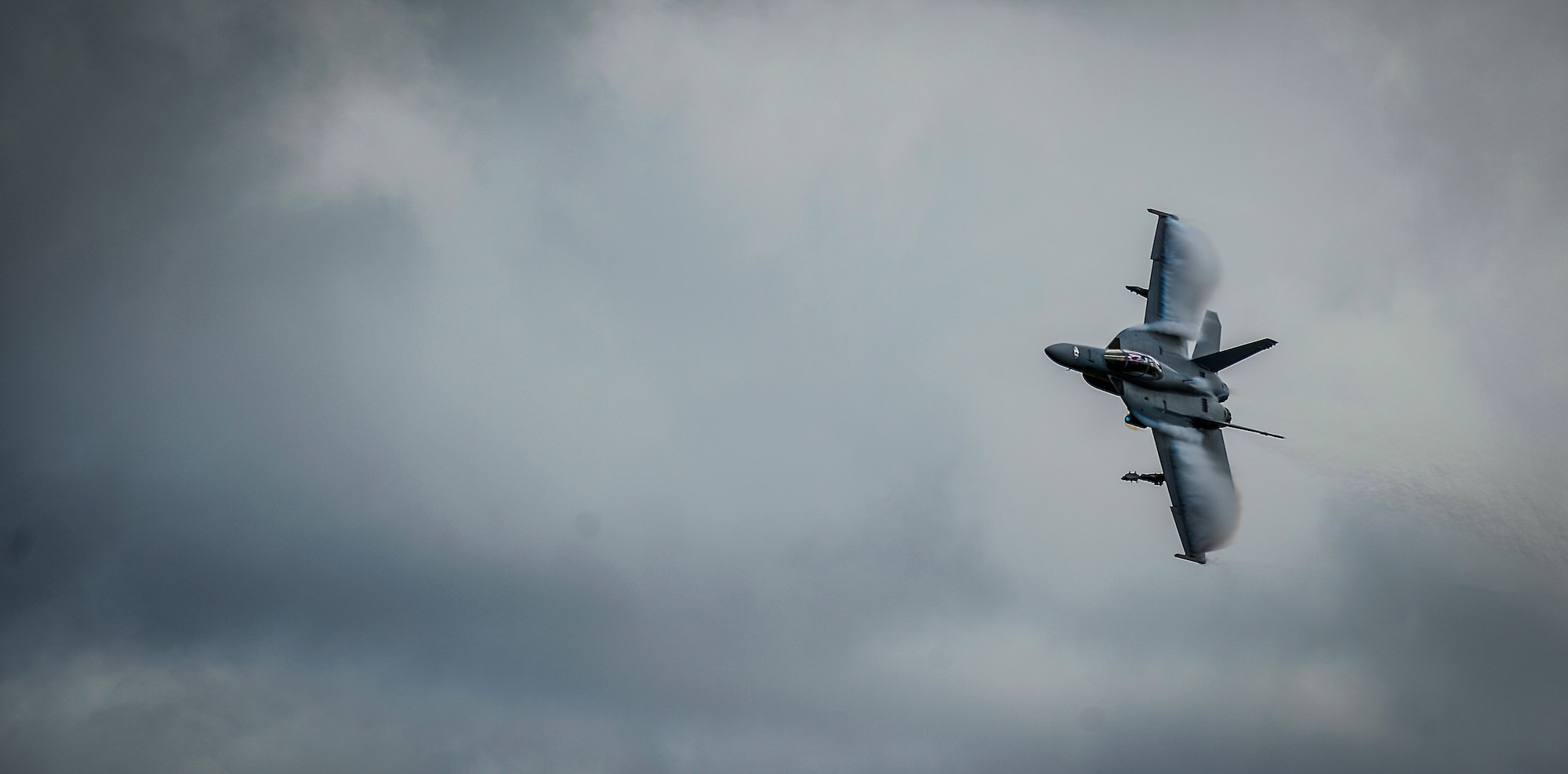 A Navy F-18 Super Hornet breaks through the clouds during a training mission held at MacDill Air Force Base, Fla., Jan. 12, 2015. Eighteen Hornets and Super Hornets participated in a VFA-106 Navy Training Exercise that instructed the fleet’s newest aviators on air-to-ground operations.  (U.S. Air Force photo by Tech. Sgt. Brandon Shapiro/Released)