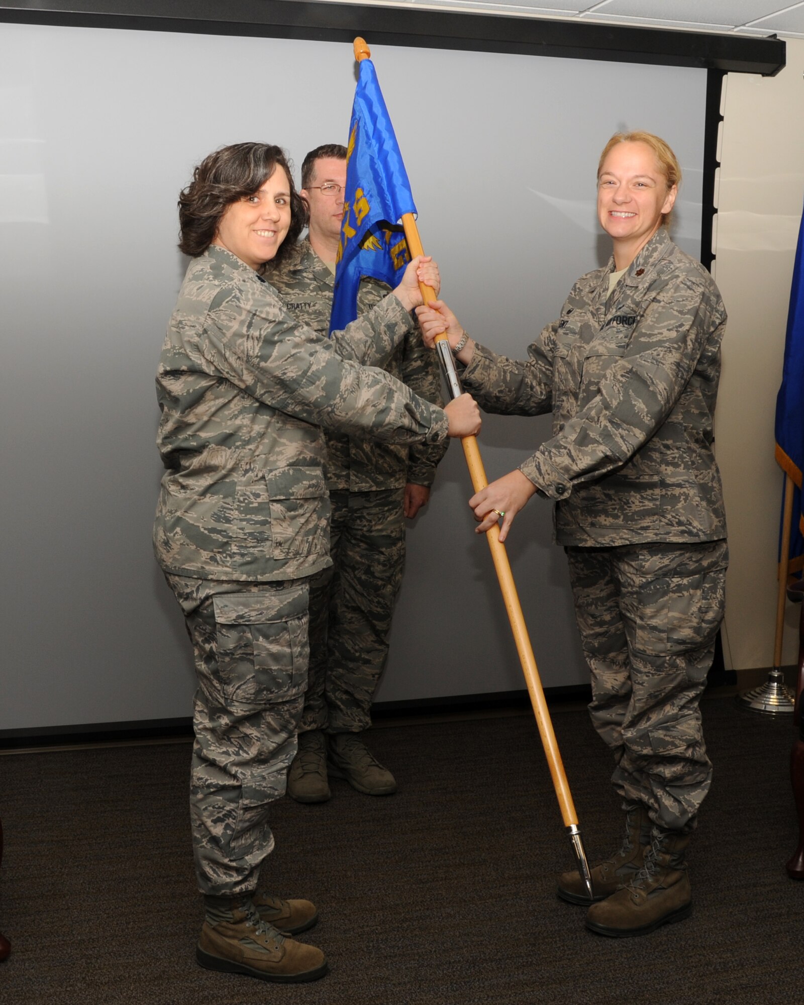 Major Mary Lent assumed command of the 927th Aircraft Maintenance Squadron in an assumption of command ceremony held here, Jan. 10. On left Lt. Col. Stephanie Mehner, 927th Maintenance Group Commander passes the 927th AMXS guidon to Major Mary Lent. (U.S. Air Force photo/Tech. Sgt. Peter Dean)