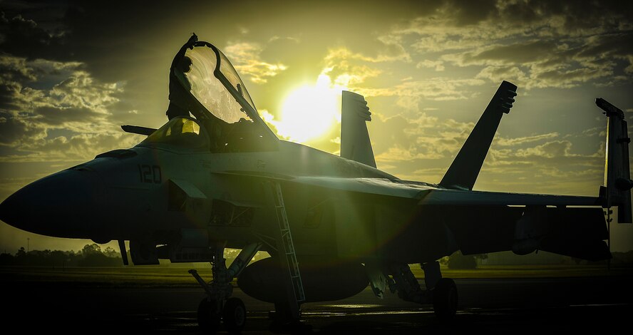 A VFA-106 crew chief from Oceana Naval Air Station, Va., prepares an F-18 Super Hornet for flight while exercising at MacDill Air Force Base, Fla., Jan. 12, 2015.  The VFA-106’s mission is to serve as the fleet replacement squadron, where they train the fleet's newest winged aviators. (U.S. Air Force photo by Tech. Sgt. Brandon Shapiro/Released)
