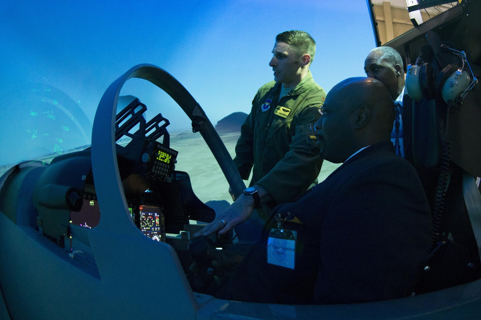 U.S. Air Force Maj. Grant Thompson, left, 81st Fighter Squadron pilot, showcases the A-29 Super Tucano simulator to civic leaders Jan. 15, 2015, at Moody Air Force Base, Ga. The A-29 is a multi-role, fixed wing aircraft that provides the Afghan air force with an indigenous counter insurgency and close air support capability. (U.S. Air Force photo by Airman 1st Class Dillian Bamman/Released)