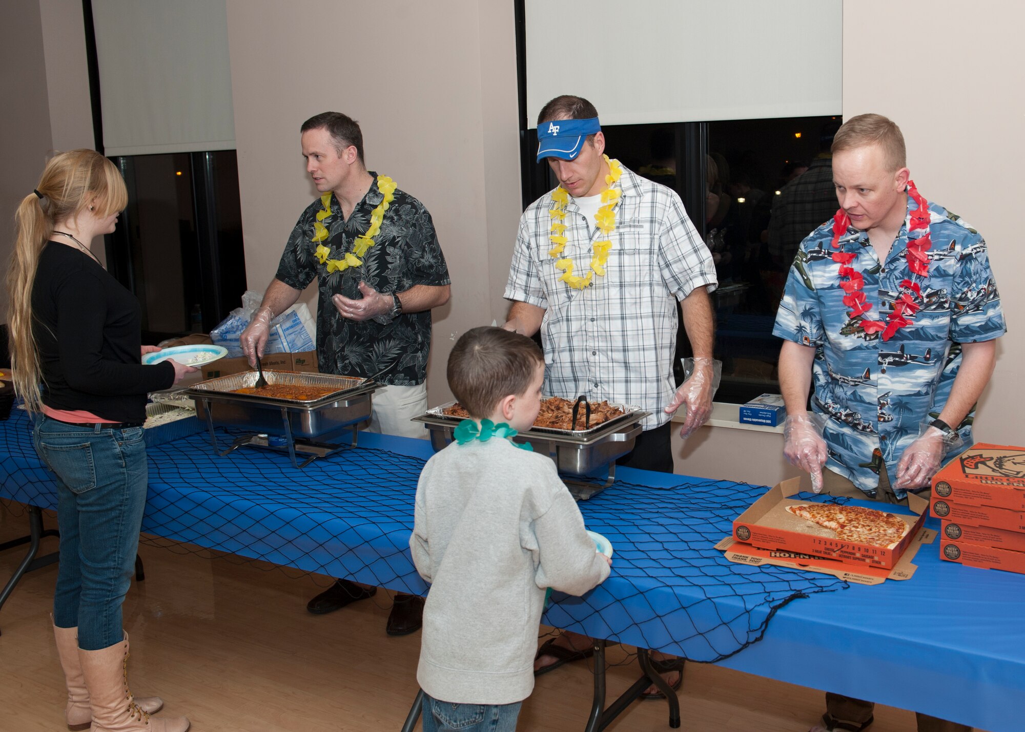 Lt. Col. Jason Mills, 3d Airlift Squadron commander, left, Lt. Col. Matthew Husemann, 9th AS commander, center, and Lt. Col. Derek Salmi, 436th Operations Support Squadron commander, serve food during a deployed families’ dinner Jan. 15, 2015, at the Youth Center on Dover Air Force Base, Del. This dinner was hosted by the 436th Operations Group. (U.S. Air Force photo/Airman 1st Class Zachary Cacicia)
