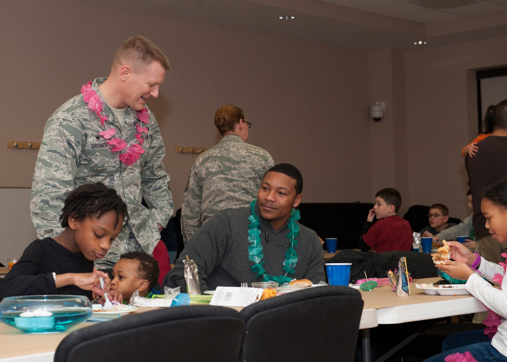 Col. Michael Grismer, 436th Airlift Wing commander, speaks to Bobby Davis, husband of Tech. Sgt. Courtney Davis, 436th Aerospace Medicine Squadron Public Health Flight chief, during a deployed families’ dinner Jan. 15, 2015, at the Youth Center on Dover Air Force Base, Del. Tech. Sgt. Davis is currently deployed overseas. (U.S. Air Force photo/Airman 1st Class Zachary Cacicia)
