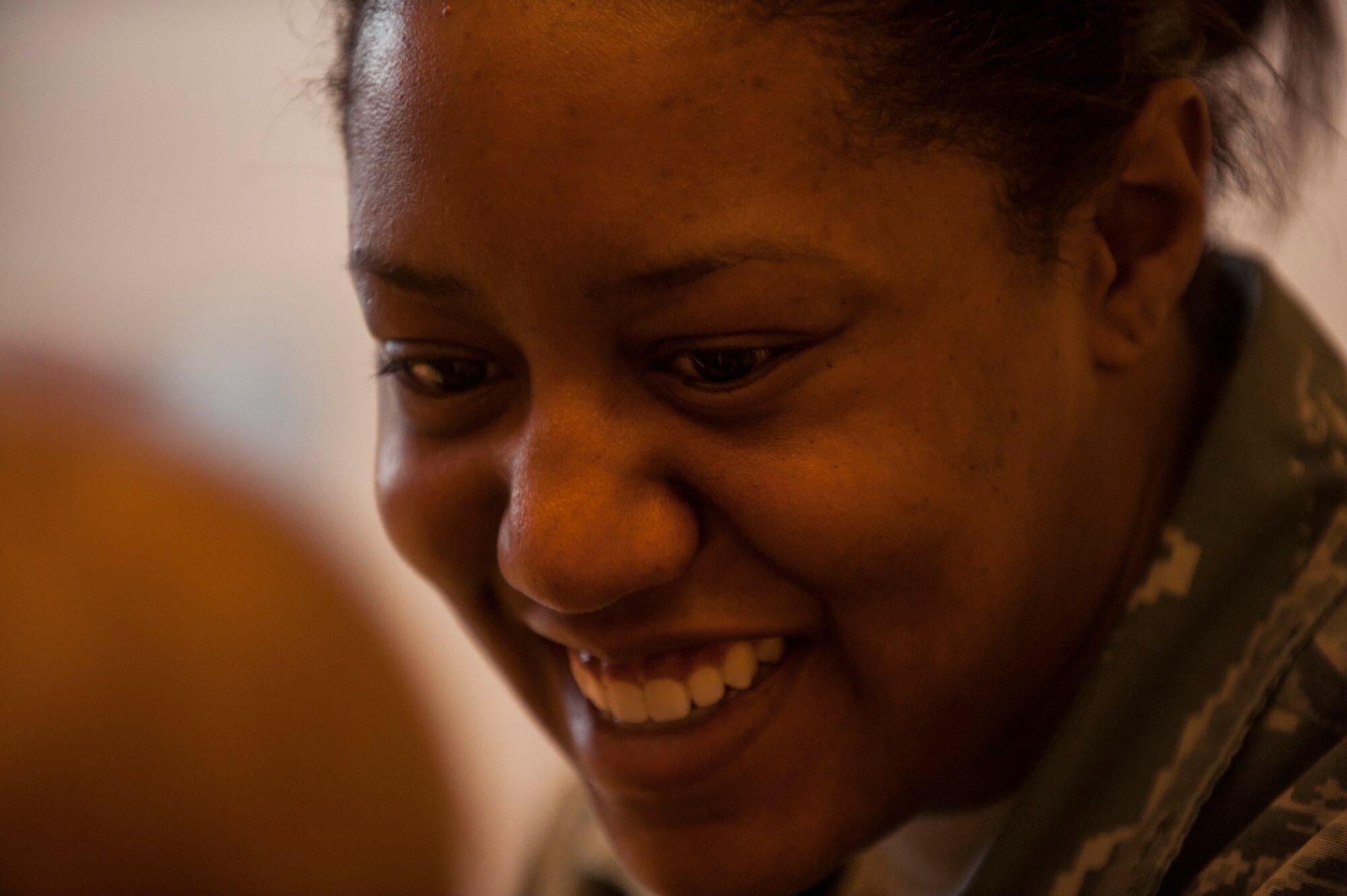 U.S. Air Force Davida Sims, a 52nd Maintenance Group commander's support staff apprentice, smiles as she reads to children during the second annual Dr. Martin Luther King Jr. "Reading is a Civil Right" reading drive Jan. 15, 2015, at a child development center at Spangdahlem Air Base, Germany. Sims and more than 50 volunteers read to nearly 200 children as a part of the drive. (U.S. Air Force photo by Senior Airman Rusty Frank/Released)