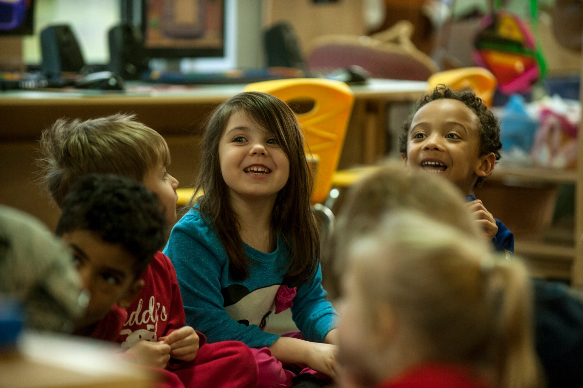Children smile after having a book read to them during the second annual Dr. Martin Luther King Jr. "Reading is a Civil Right" reading drive Jan. 15, 2015, at a child development center at Spangdahlem Air Base, Germany. More than 50 volunteers read to nearly 200 children as a part of the drive. (U.S. Air Force photo by Senior Airman Rusty Frank/Released)