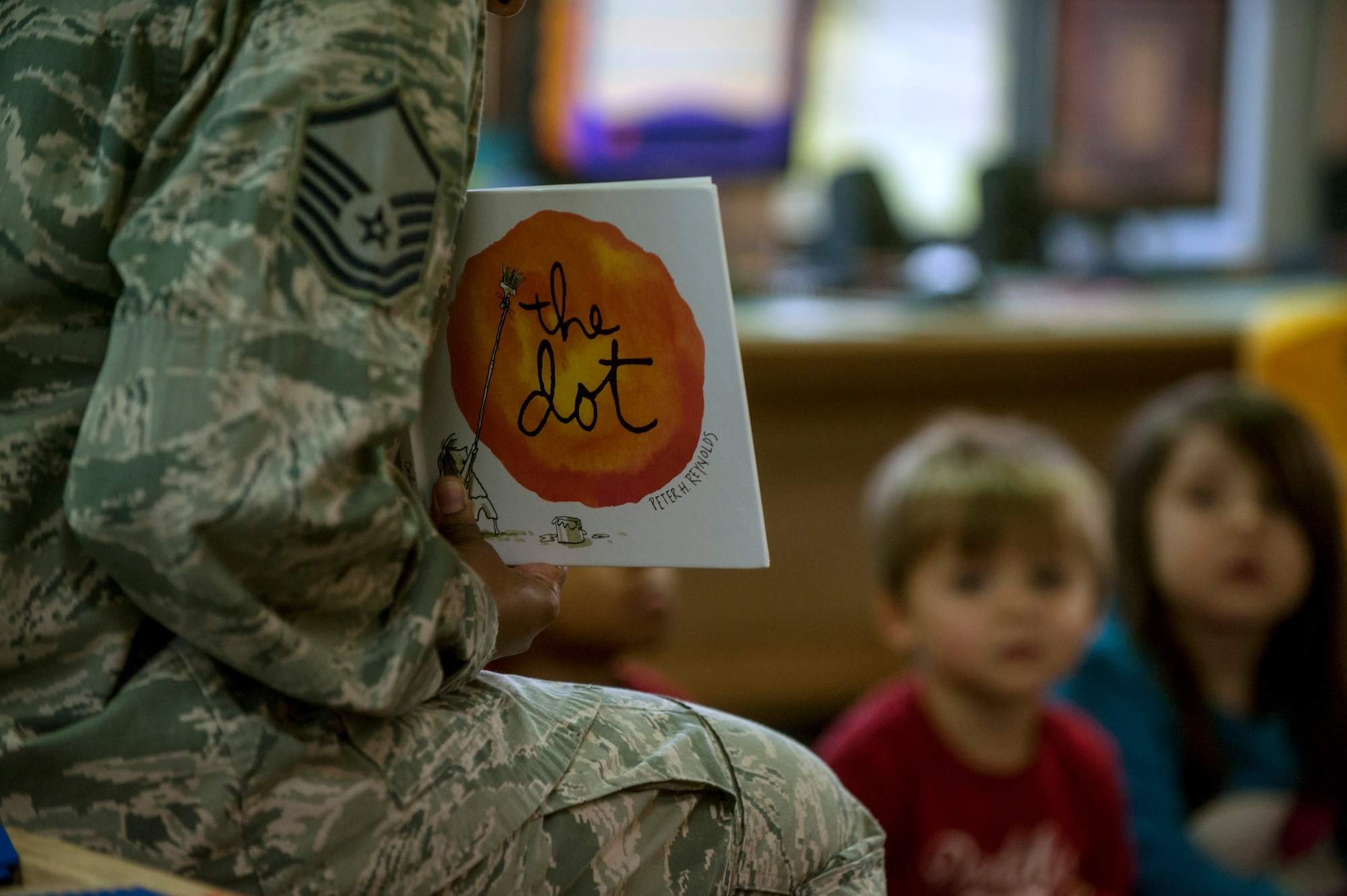 Children listen as a book is read to them during the second annual Dr. Martin Luther King Jr. "Reading is a Civil Right" reading drive Jan. 13, 2015, at a child development center Spangdahlem Air Base, Germany. More than 50 Airmen volunteered to read to the children during the week. (U.S. Air Force photo by Senior Airman Rusty Frank/Released)