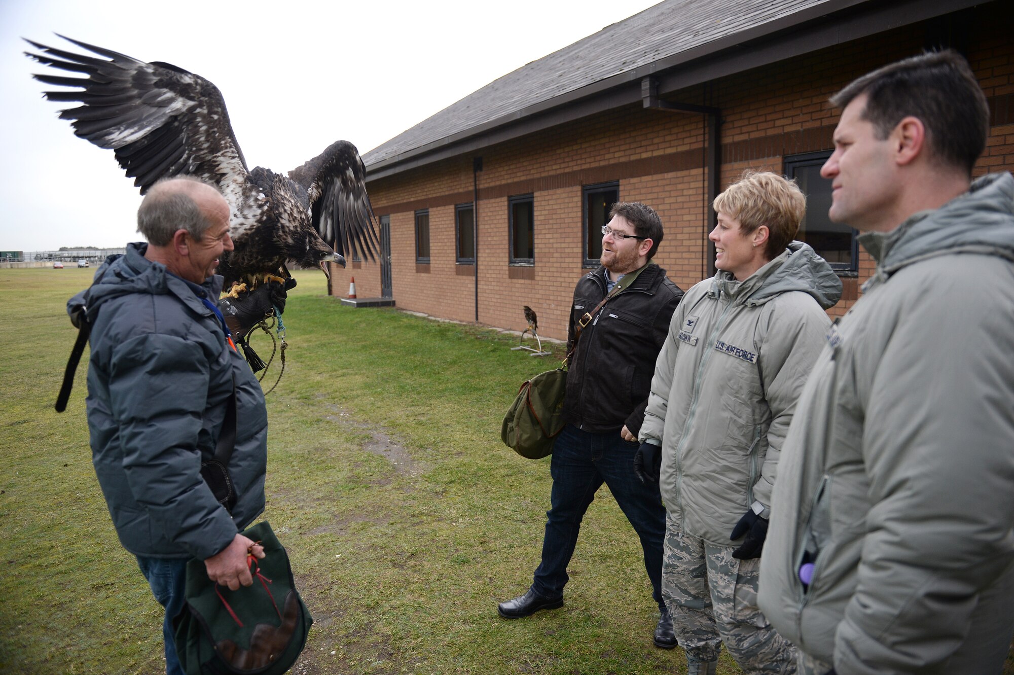 Keith Mutton, left, owner of Phoenix Bird Control Service, holds a Bald Eagle at a birds-of-prey demonstration during an Installation ExcellenceSelection Board visit on Royal Air Force Lakenheath, England, Jan. 15, 2015. The IESB visited RAF Lakenheath to determine the winner of the Commander in Chief’s Annual Award for Installation Excellence. (U.S. Air Force photo by Staff Sgt. Emerson Nuñez/Released)