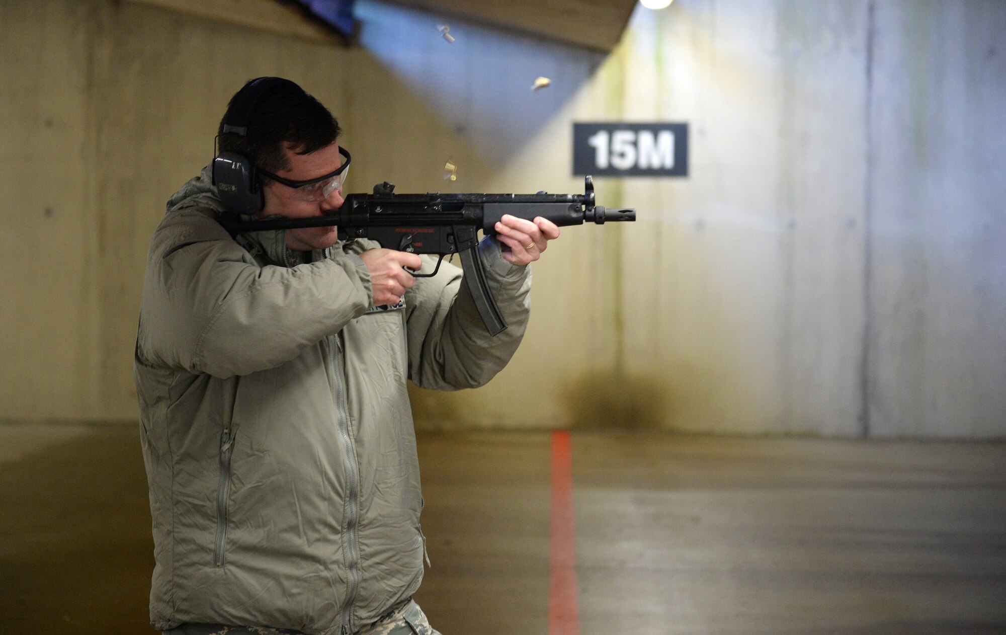Col. John Devillier, 88th Air Base Wing commander, fires an MP5 submachine gun during an Installation Excellence Selection Board visit on Royal Air Force Feltwell, England, Jan. 15, 2015. The IESB visited RAF Lakenheath to determine the winner of the Commander in Chief’s Annual Award for Installation Excellence. (U.S. Air Force photo by Staff Sgt. Emerson Nuñez/Released)