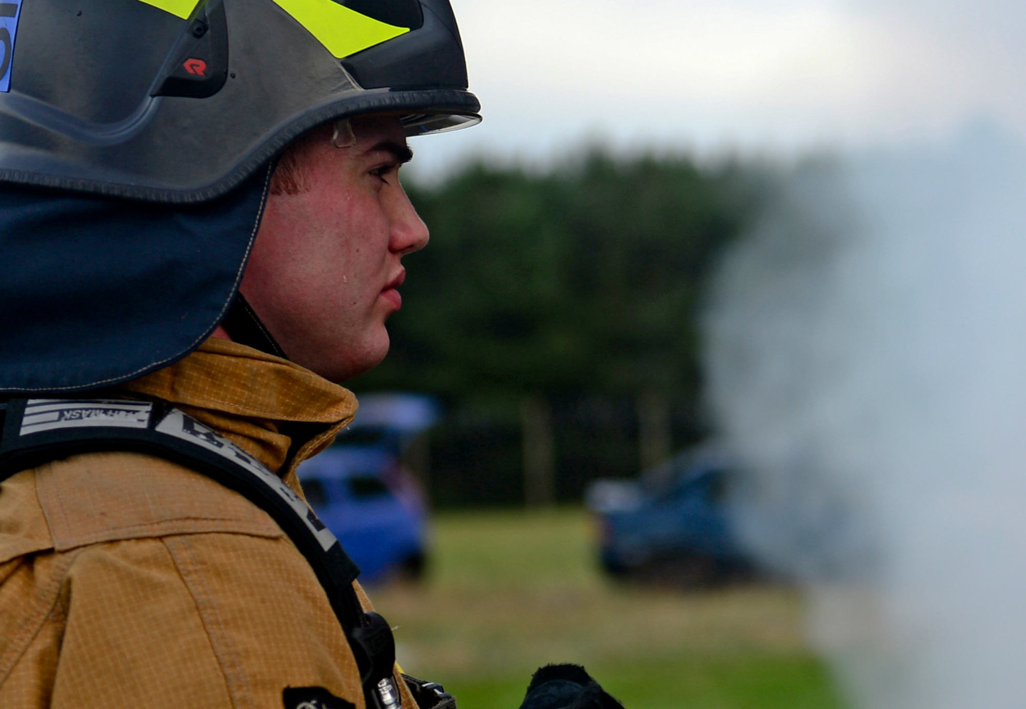 Airman Clayton Proctor, 48th Civil Engineer Squadron firefighter, prepares to enter a building during a structure fire exercise at Royal Air Force Lakenheath, England, Jan. 16, 2015. Firefighters assigned to the 48th Civil Engineer Squadron conduct scenario exercises in order to stay proficient in their skills. (U.S. Air Force photo by Senior Airman Erin O’Shea/Released)