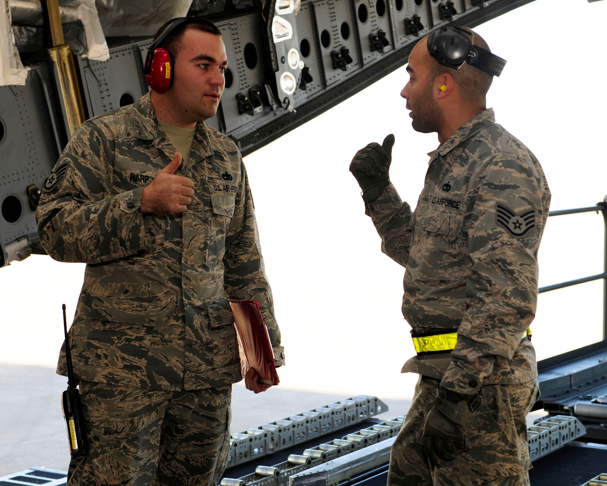 Staff Sgt. Wade Harp, 728th Air Mobility Squadron air terminal operation center controller, and Staff Sgt. Anthony Felix, 728th AMS aircraft services supervisor, discuss the transportation of cargo Jan. 14, 2015, at Incirlik Air Base, Turkey. Harp and Felix oversee the loading and unloading of cargo onto aircrafts. (U.S. Air Force photo by Senior Airman Krystal Ardrey/Released)