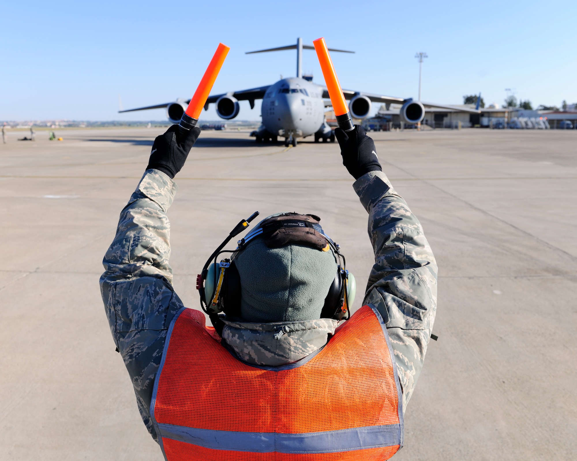Master Sgt. Robert Farrell, 446th Aircraft Maintenance Operations Squadron electronic and environmental technician, marshals a C-17 Globemaster III for takeoff Jan. 14, 2015, at Incirlik Air Base, Turkey. Farrell is assigned to the U.S. Air Force Reserves Command at Joint Base Lewis – McChord performing his two weeks of continuous duty with the 728th Air Mobility Squadron. (U.S. Air Force photo by Senior Airman Krystal Ardrey/Released)