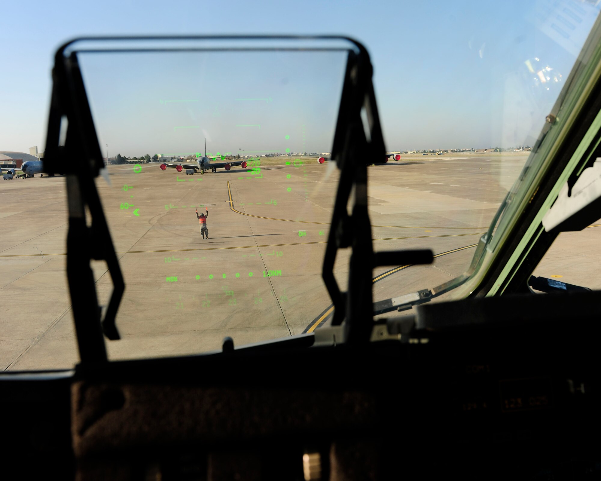 Master Sgt. Robert Farrell, 446th Aircraft Maintenance Operations Squadron electronic and environmental technician, marshals a C-17 Globemaster III for takeoff Jan. 14, 2015, at Incirlik Air Base, Turkey. Farrell is working with the 728th Air Mobility Squadron as one of more than 90 augmentees to assist in flightline operations. (U.S. Air Force photo by Senior Airman Krystal Ardrey/Released)