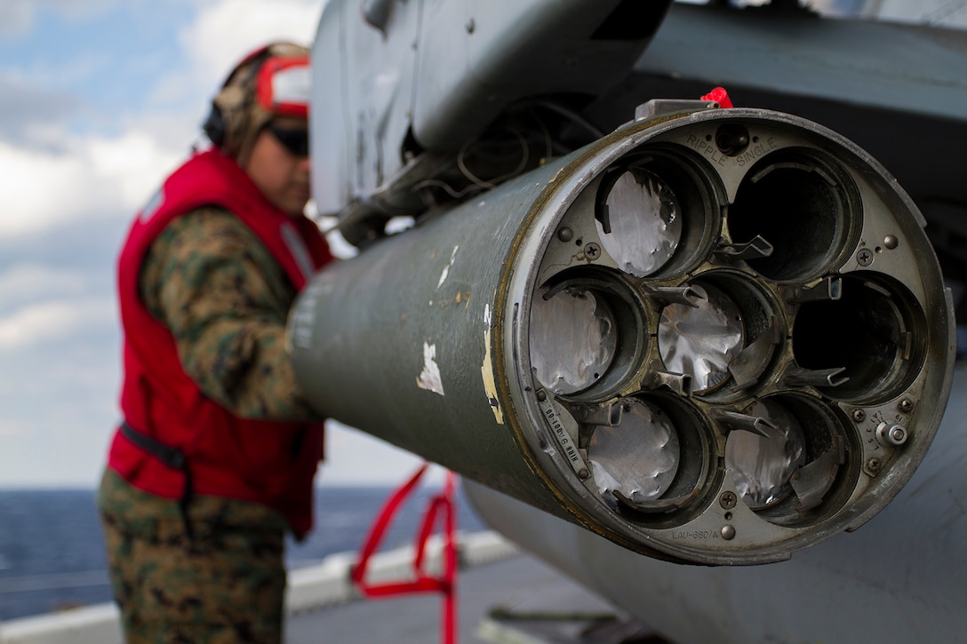 Gunnery Sergeant Edward Lujan, an aviation ordnance chief with Marine Medium Tiltrotor Squadron 365 (Reinforced), 24th Marine Expeditionary Unit, loads a 2.75-inch rocket in to a LAU-68 rocket pod attached to an AH-1W Cobra attack helicopter aboard USS Iwo Jima (LPD 7) Jan. 7, 2015. The 24th MEU and Iwo Jima Amphibious Ready Group are conducting naval operations in the U.S. 6th Fleet area of operations in support of U.S. national security interests in Europe. (U.S. Marine Corps photo by Lance Corporal Dani A. Zunun)