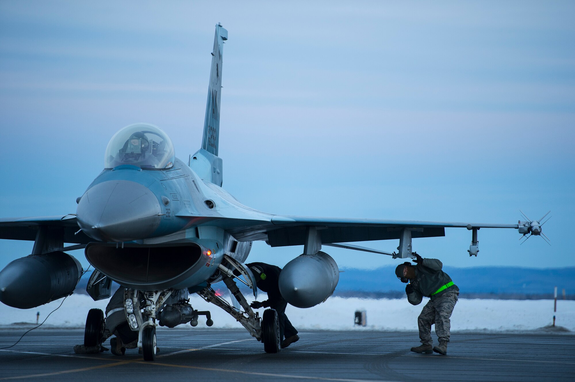 Eielson Icemen assigned to the 354th Aircraft Maintenance Squadron conduct a final inspection on an F-16 Fighting Falcon prior to take off from Eielson Air Force Base, Alaska, Jan. 17. 2015.  More than 150 maintainers will keep the 18th Aggressor Squadron in the air during Pacific Air Forces exercises, which are meant to prepare U.S. Airmen, Sailors and Marines along with coalition partners in the Pacific theater of operations for contingency operations if the need arises. (U.S. Air Force photo by Senior Airman Peter Reft/Released)  