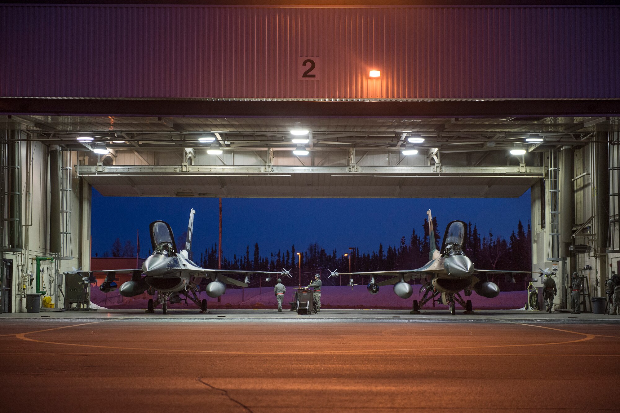 Eielson Icemen assigned to the 354th Aircraft Maintenance Squadron and 18th Aggressor Squadron (AS) prepare F-16 Fighting Falcons for take off from Eielson Air Force Base, Alaska, Jan. 17. 2015.  More than 150 maintainers will keep the 18th AS in the air during Pacific Air Forces exercises, which are meant to prepare U.S. Airmen, Sailors and Marines along with coalition partners in the Pacific theater of operations for contingency operations if the need arises. (U.S. Air Force photo by Senior Airman Peter Reft/Released)
