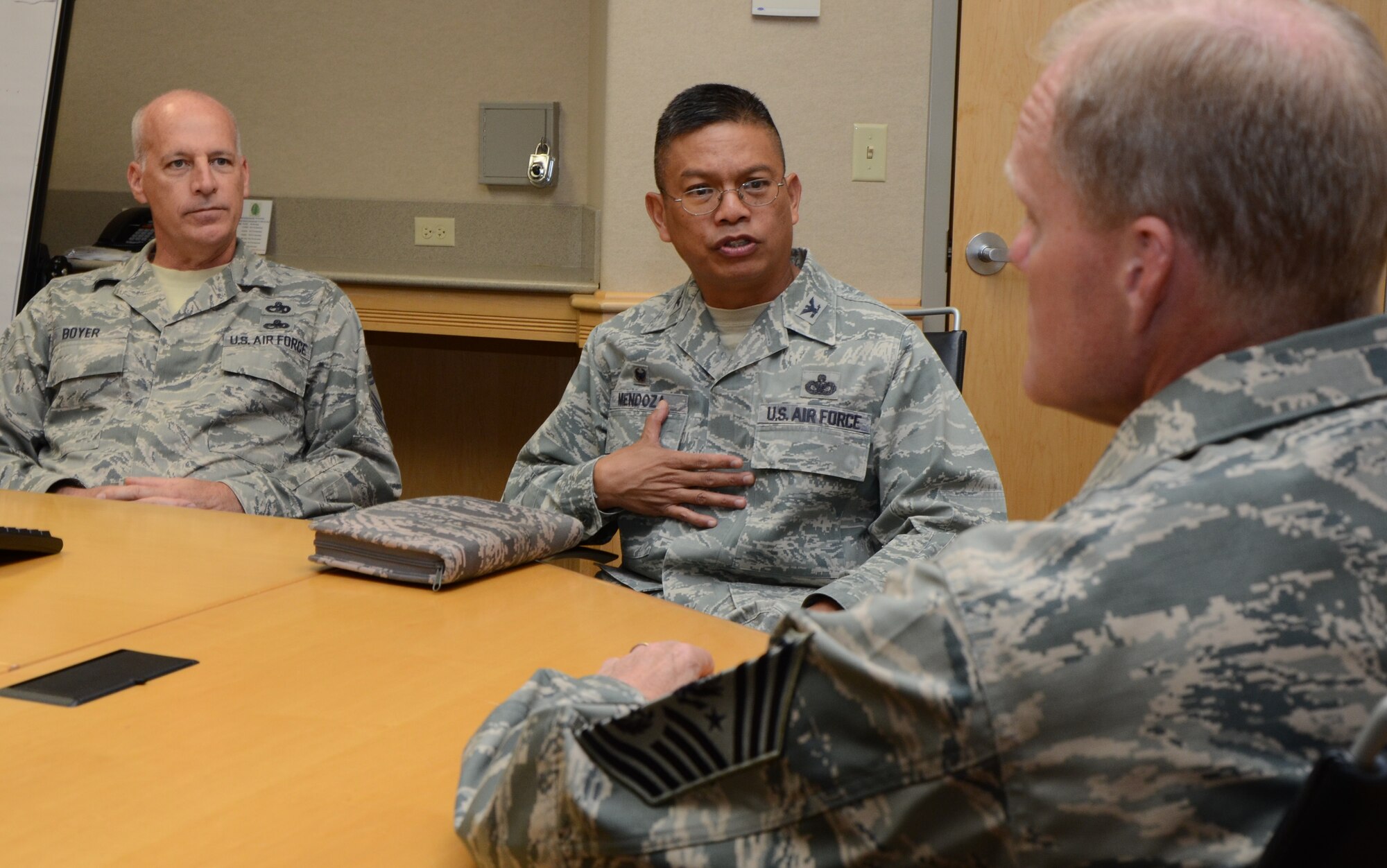 Col. Maynard "Max" Mendoza, center, commander of the 624th Regional Support Group, briefs Chief Master Sgt. of the Air Force James Cody, right, on the role the Air Force Reserve plays in the Pacific Theater, while Chief Master Sgt. Gregory Boyer, left, chief enlisted manager for the 48th Aerial Port Squadron, looks on, Joint Base Pearl Harbor-Hickam, Hawai'i, Jan. 16, 2015. Colonel Mendoza and Chief Boyer have more than 50 years of combined experience on active duty and in the Air Force Reserve. (U.S. Air Force photo by Tech. Sgt. Phyllis Keith)

