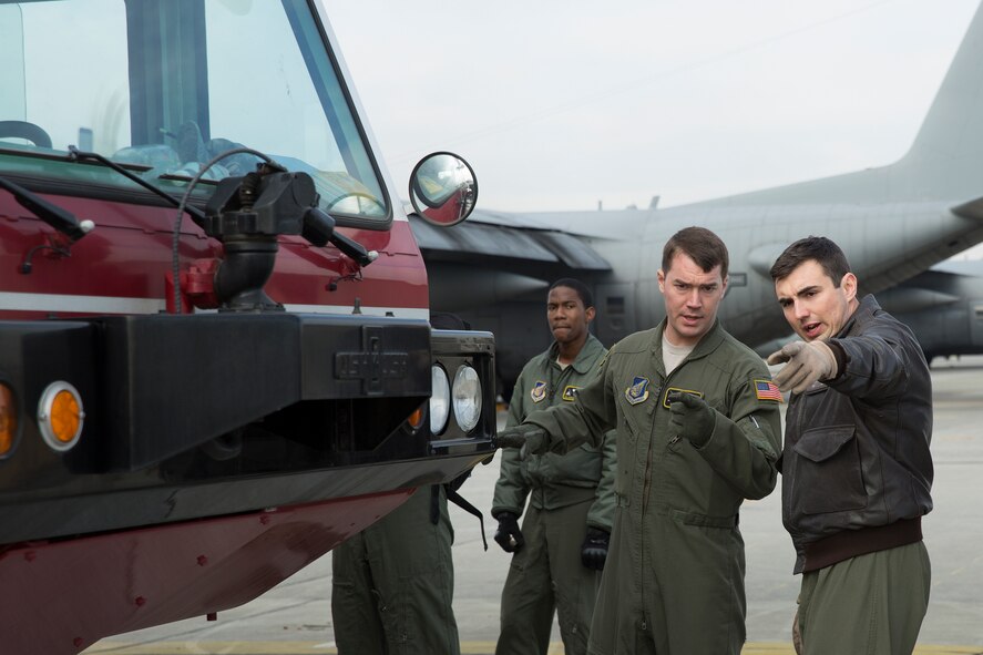 (Right to left) Staff Sgt. Dmitri Sokgobenzon and Senior Airman Andrew Fox, both 36th Airlift Squadron loadmasters, inspect a P-19 Aircraft Rescue Fire Fighting vehicle before loading it onto a C-130 Hercules at Yokota Air Base, Japan, Jan. 14, 2015, during a Samurai Readiness Inspection. The inspection was designed to evaluate Yokota’s ability to provide airlift capabilities while responding to a variety of contingency response scenarios. (U.S. Air Force photo by Osakabe Yasuo/Released) 