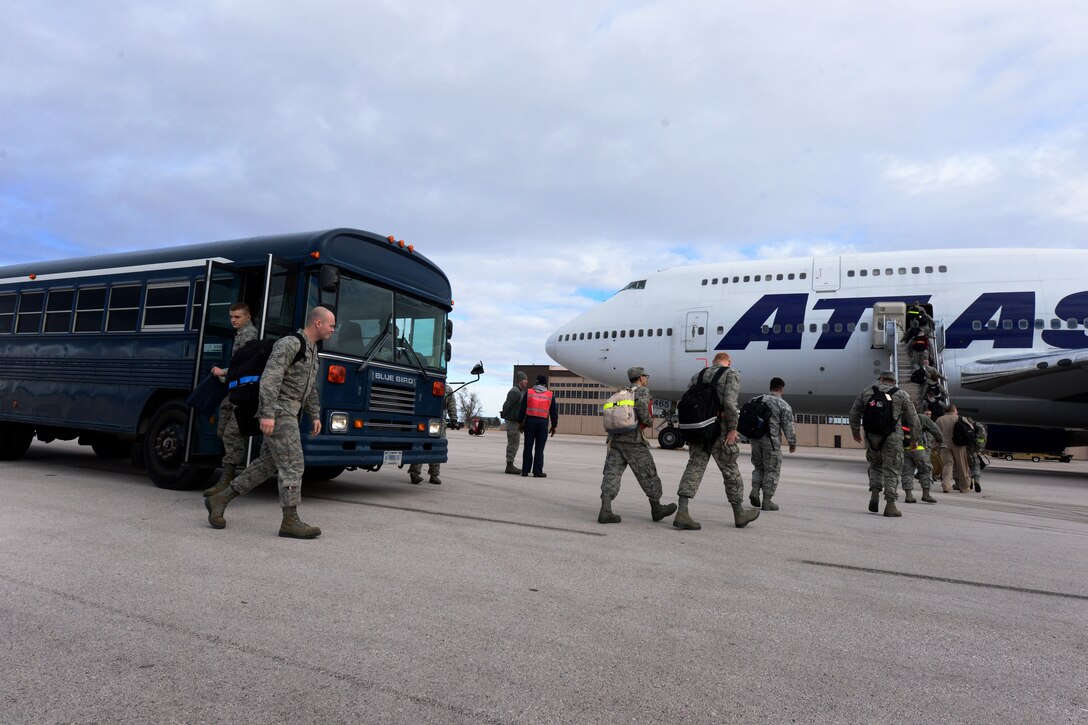 Ellsworth Airmen board a commercial Boeing 747 aircraft as part of a deployment to Southwest Asia at Ellsworth Air Force Base, S.D., Jan. 20, 2015. Aircrews from Ellsworth will provide critical air presence, precision strike and surveillance and reconnaissance capabilities to support the military objectives in the U.S. Central Command area of responsibility. (U.S. Air Force photo by Senior Airmen Zachary Hada/Released) 