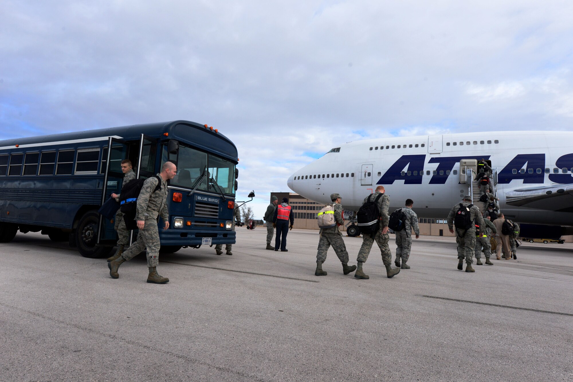 Ellsworth Airmen board a commercial Boeing 747 aircraft as part of a deployment to Southwest Asia at Ellsworth Air Force Base, S.D., Jan. 20, 2015. Aircrews from Ellsworth will provide critical air presence, precision strike and surveillance and reconnaissance capabilities to support the military objectives in the U.S. Central Command area of responsibility. (U.S. Air Force photo by Senior Airmen Zachary Hada/Released) 