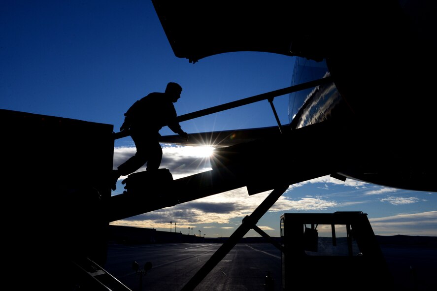 Senior Airman Paul Visico, 28th Aircraft Maintenance Squadron weapons load crewmember, loads luggage into a commercial Boeing 747 aircraft set for a deployment to Southwest Asia at Ellsworth Air Force Base, S.D., Jan. 20, 2015. Ellsworth aircrews, maintenance and support personnel will be providing operational support to the 379th Expeditionary Wing, helping to ensure multirole airpower in the U.S. Central Command area of responsibility. (U.S. Air Force photo by Senior Airmen Zachary Hada/Released)
