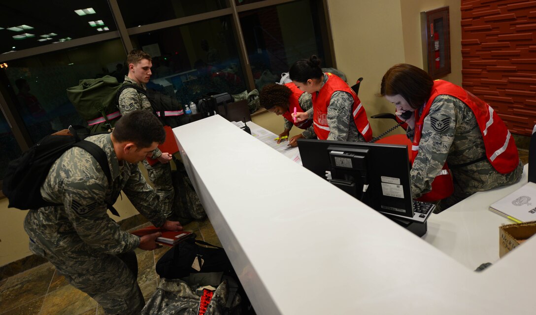 Ellsworth Airmen go through a mobility line at the Deployment Center at Ellsworth Air Force Base, S.D., prior to a deployment to Southwest Asia Jan. 20, 2015. More than 350 Airmen were checked through the center during the deployment period to ensure both equipment and military documentation satisfied travel requirements. (U.S. Air Force photo by Senior Airmen Zachary Hada/Released)