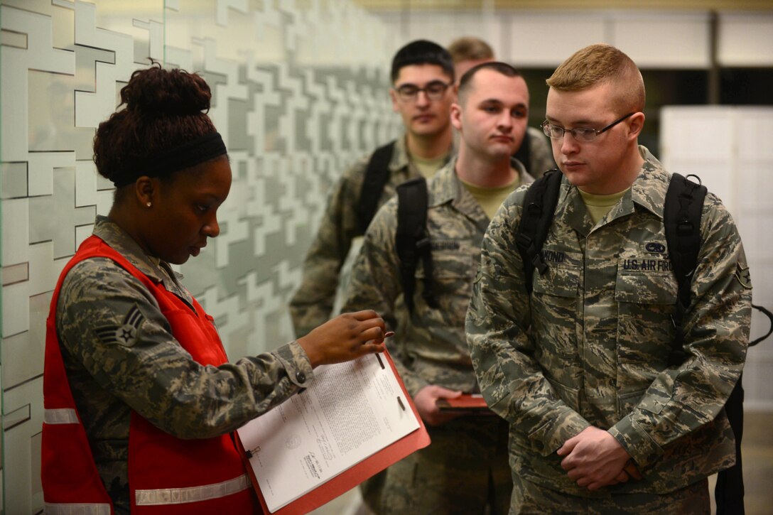 Senior Airman Wintera Jones, 28th Force Support Squadron installation readiness technician, reviews deployers’ military orders at the Deployment Center at Ellsworth Air Force Base, S.D., Jan. 20, 2015. Ellsworth aircrews, maintenance and support personnel are deploying to Southwest Asia to provide operational support to the 379th Expeditionary Wing, helping ensure multirole airpower in the U.S. Central Command area of responsibility. (U.S. Air Force photo by Senior Airmen Zachary Hada/Released)