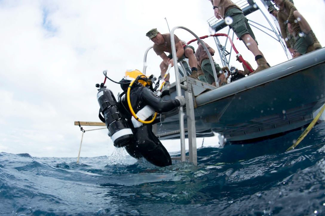 Navy Petty Officer 1st Class Carlos Hernandez ascends a ladder during diver training aboard the USAV Matamoros on Naval Air Station Key West, Fla. Jan. 13, 2015. Hernandez is a builder assigned to the Underwater Construction Team One.  
