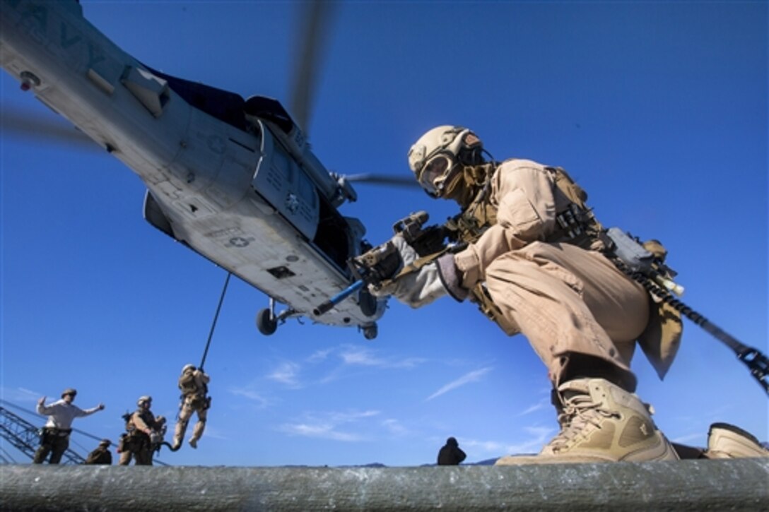 Marines fast-rope from an MH-60R Seahawk helicopter while training off the coast of Santa Barbara, Calif., Jan. 16, 2015. The Marines are assigned to the 15th Marine Expeditionary Unit, Maritime Raid Force.