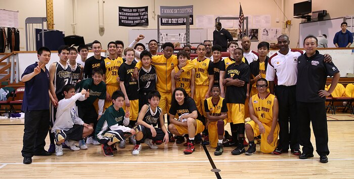 Matthew C. Perry High School Samurai basketball team poses with the Tabuse Agricultural Technical High School basketball team on Jan. 18, 2015 at the high school gymnasium aboard Marine Corps Air Station Iwakuni, Japan. The Samurai won the game against their Japanese counterparts with a score of 57-29 and continue to dominate this season with an undefeated streak of 11-0. 