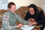 Local women receive training about how to manage bee hives for the Kapisa Honeybee Project that the Kentucky National Guard's Agricultural Development Team, attached to the 86th Infantry Brigade Combat Team of the Vermont National Guard, is facilitating, April 6, 2010. The project involves supplying women in Kapisa with beehives and training on how to manage the hives so that they can harvest and sell the honey.