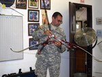 Spc. Shawn Porter of the Texas Army National Guard demonstrates the bow and arrow he will use during the Warrior/U.S. Paralympic Games in Colorado Springs, Colo., May 11-14, 2010.