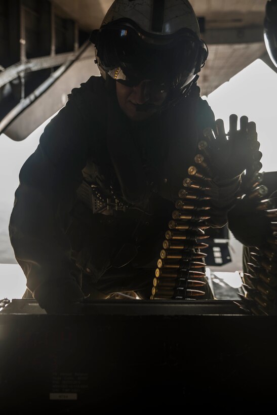 Sgt. Ryan Hetu, from Pittsfield, New Jersey, loads rounds into an ammo can while flying in a CH-53E Super Stallion Jan. 14 during exercise Lava Viper 15-1.2 at Pohakuloa Training Area, Hawaii. The rounds will be used by a GAU-21 .50-caliber machine gun. The ammo can holds 300 .50-caliber rounds. Two CH-53Es flew on a simulated air mission. The training improves the aerial gunners’ ability to engage targets and coordinate fire between two aircraft. The aircraft is from Marine Heavy Helicopter Squadron 463, Marine Aircraft group 24, 1st Marine Aircraft Wing. Hetu is a crew chief with HMH-463.